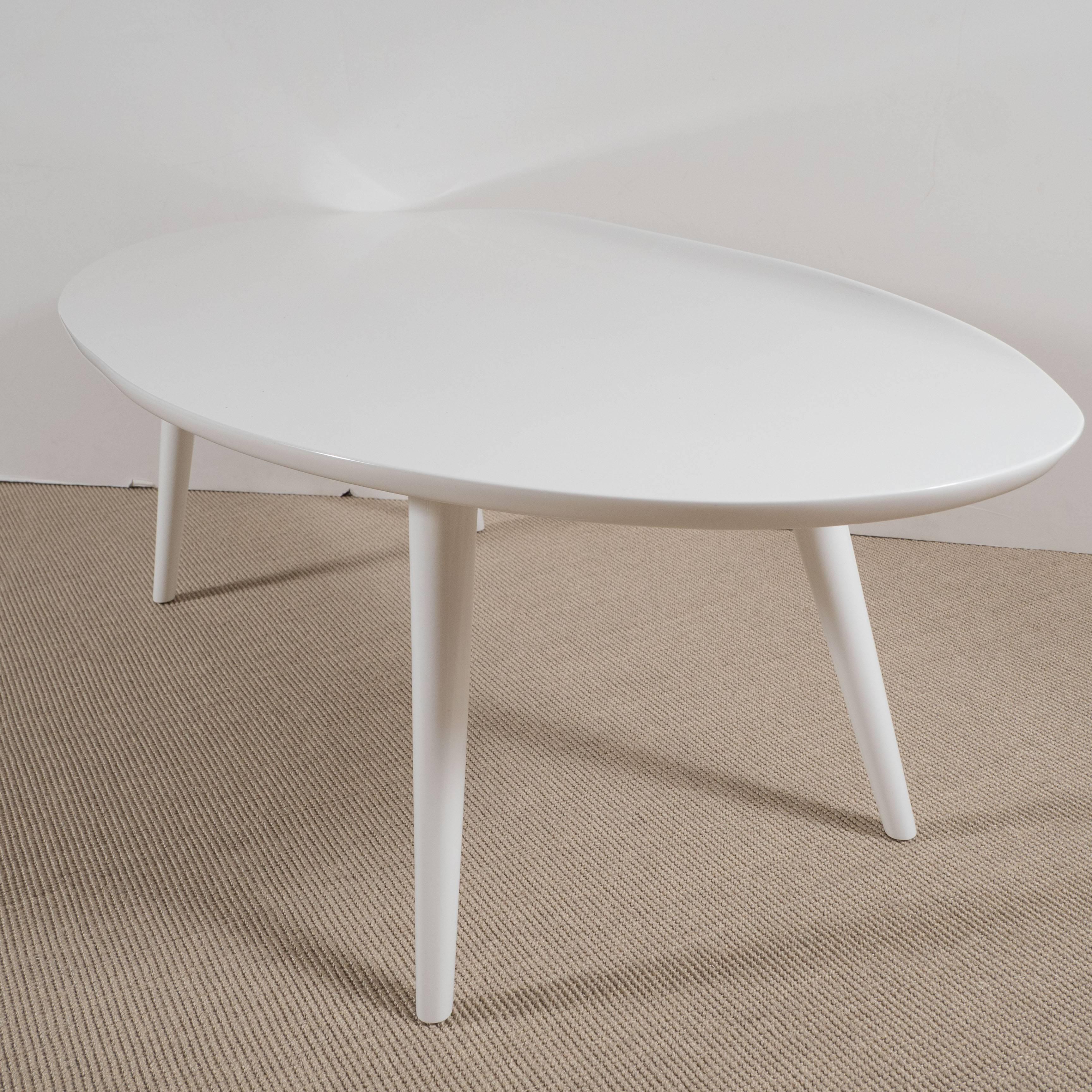 White lacquer Conant Ball makers coffee tables with curved lip,
splayed tapering slender legs.
  