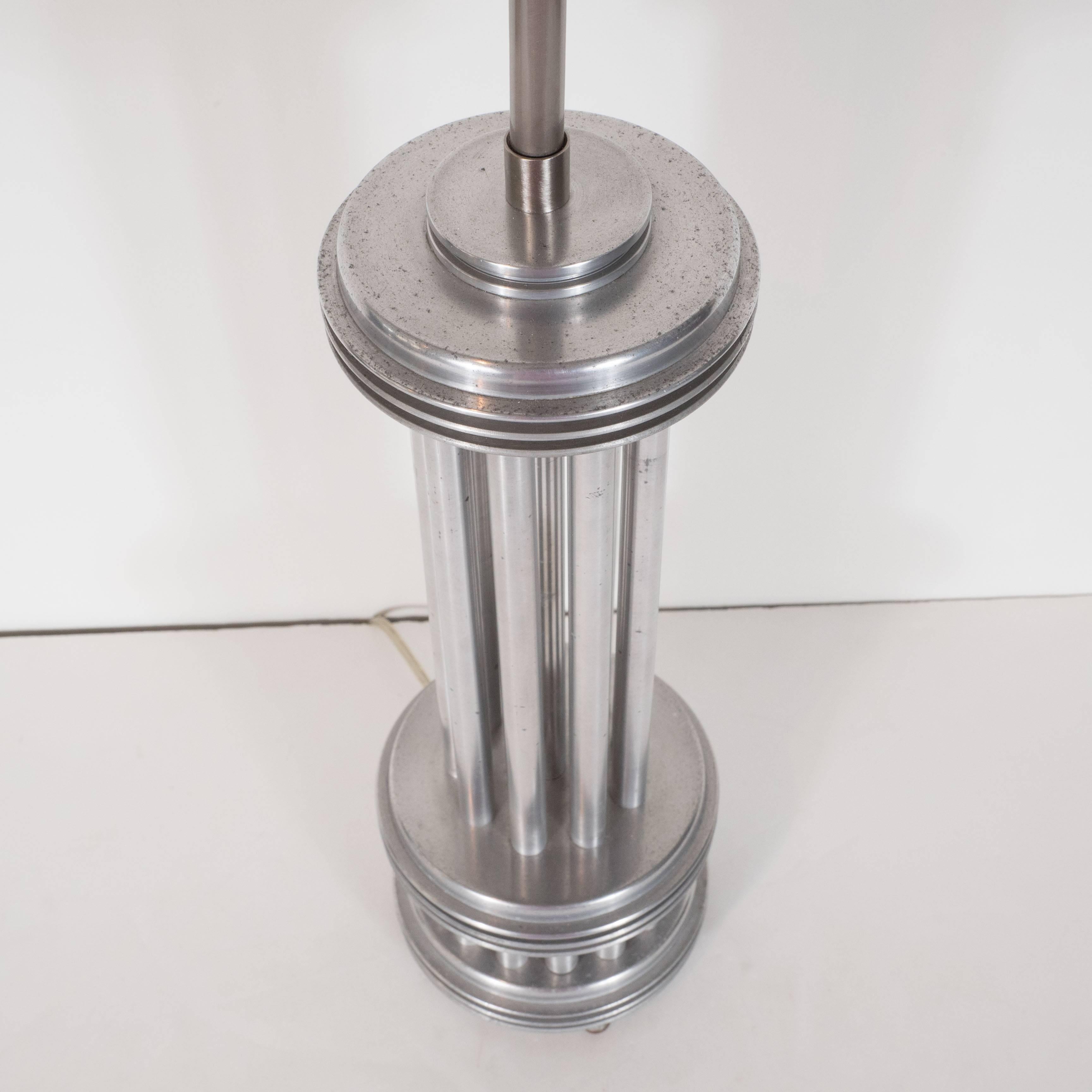 An American aluminum Machine Age deco,
constructed table lamp, 1930s, with vertical,
rods between discs.
  