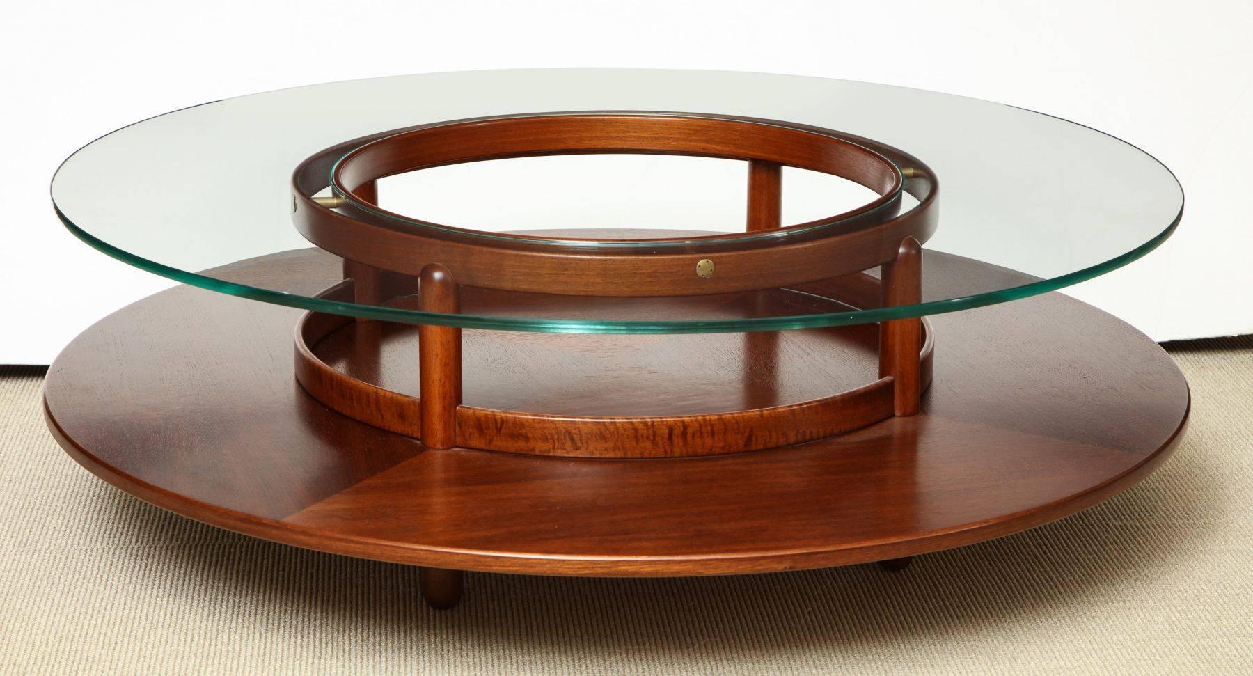 Round low table in rosewood with glass top and brass fittings by Giafranco Frattini for Cassina, Italy, circa 1960.