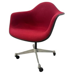 VIntage Red Upholstered Swivel Chair On Wheels By Charles And Ray Eames