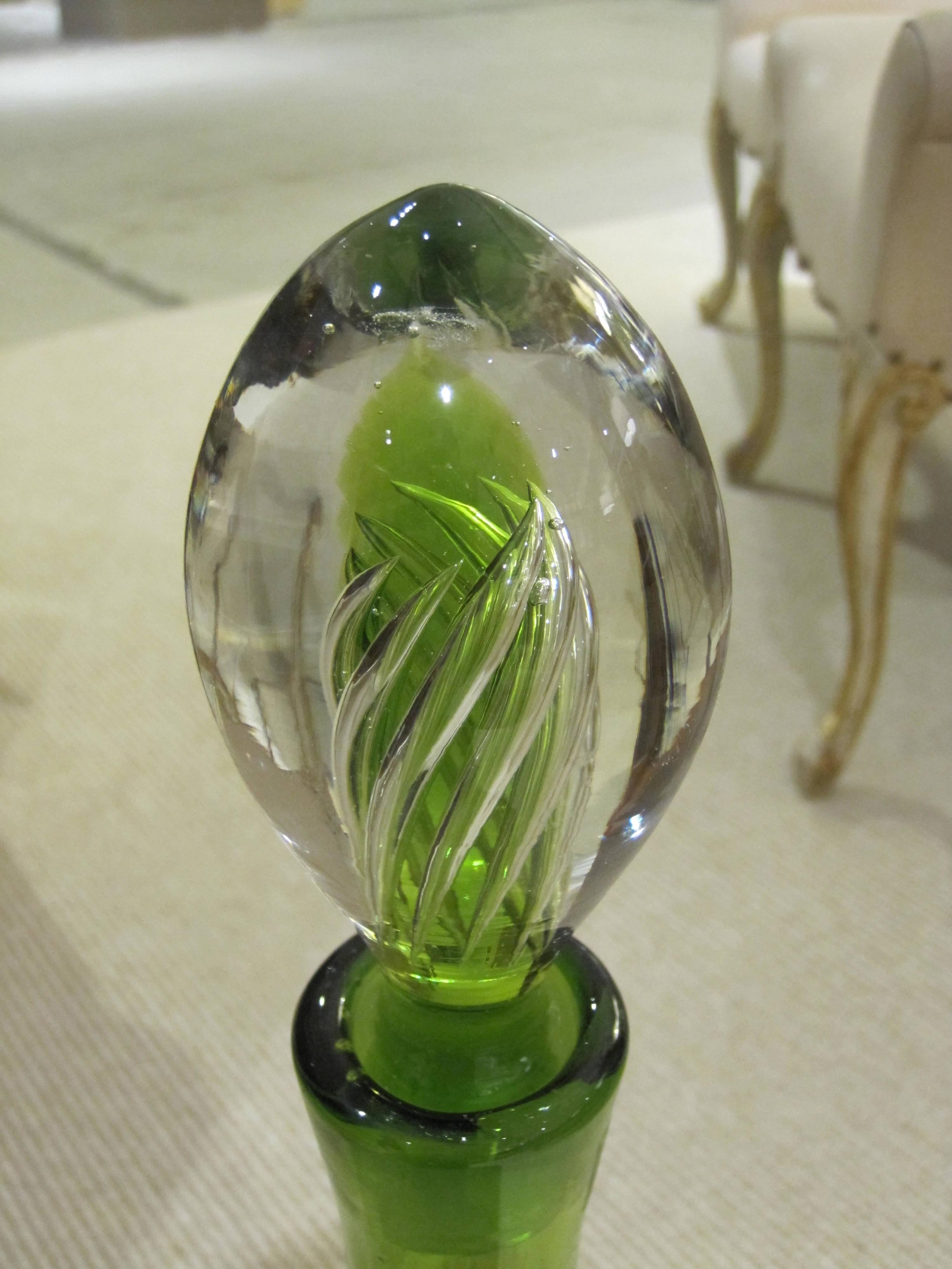 A tall and striking American 1960s handblown apple-green decanter by Blenko Glassworks; the bulbous shaped body with long neck of heavy handblown glass fitted with a solid glass stopper.