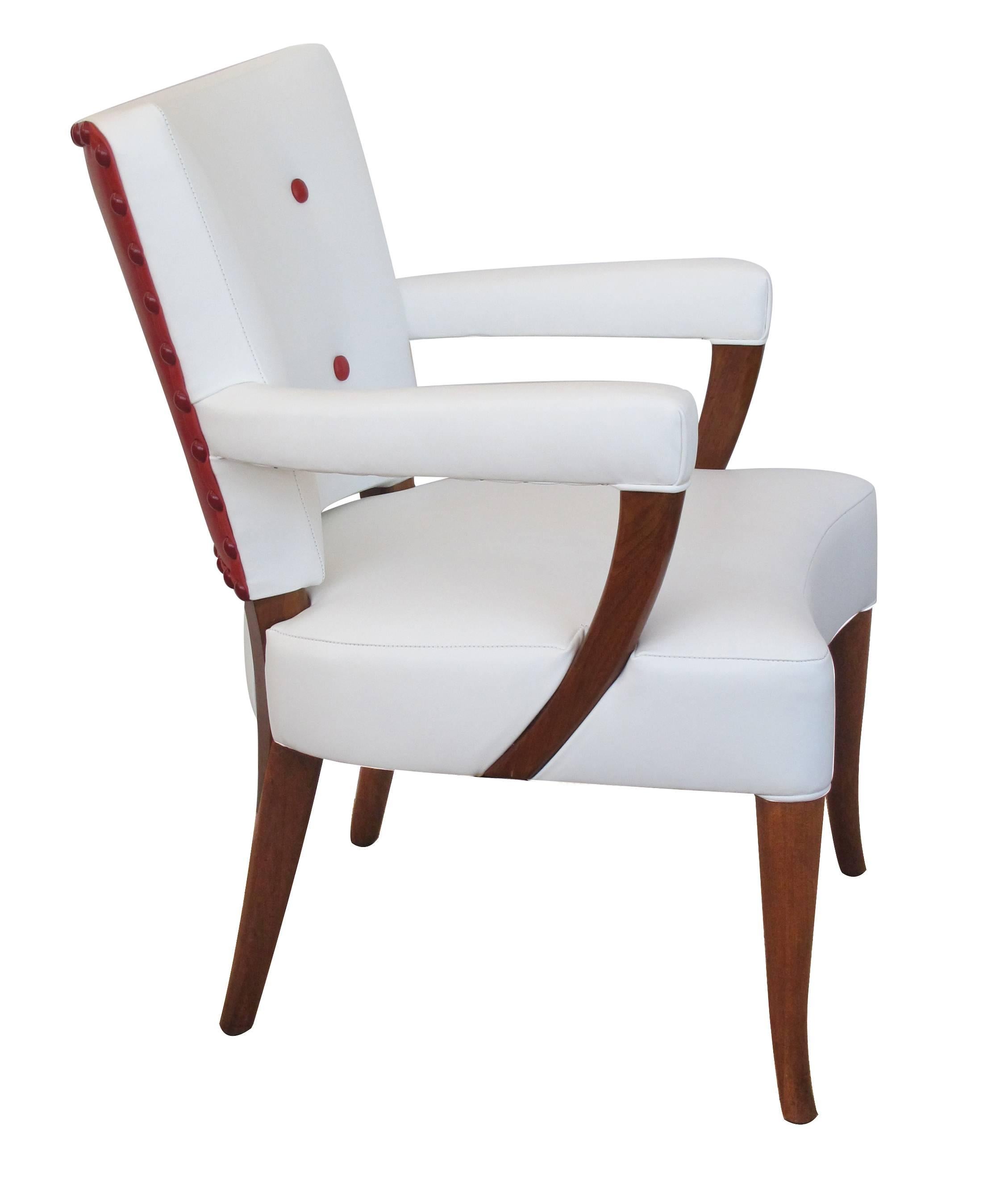 A stylish and well-proportioned set of four American, 1940s white and red leather upholstered arms/game chairs, Stow and Davis Furniture Co. from their executive line guild, each with warmly patinated frame.