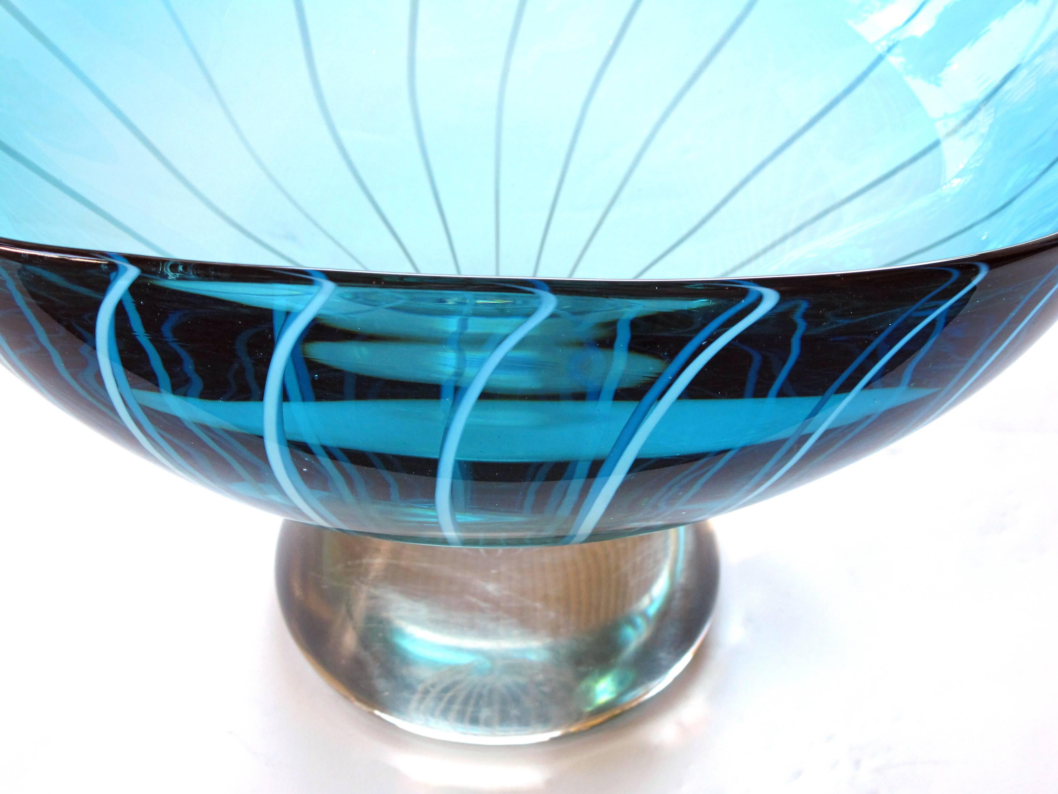 A large-scaled Murano 1960's teal art glass bowl with white swirl decoration; of oblong shape in a teal blue glass with swirling white motif; raised on a splayed foot