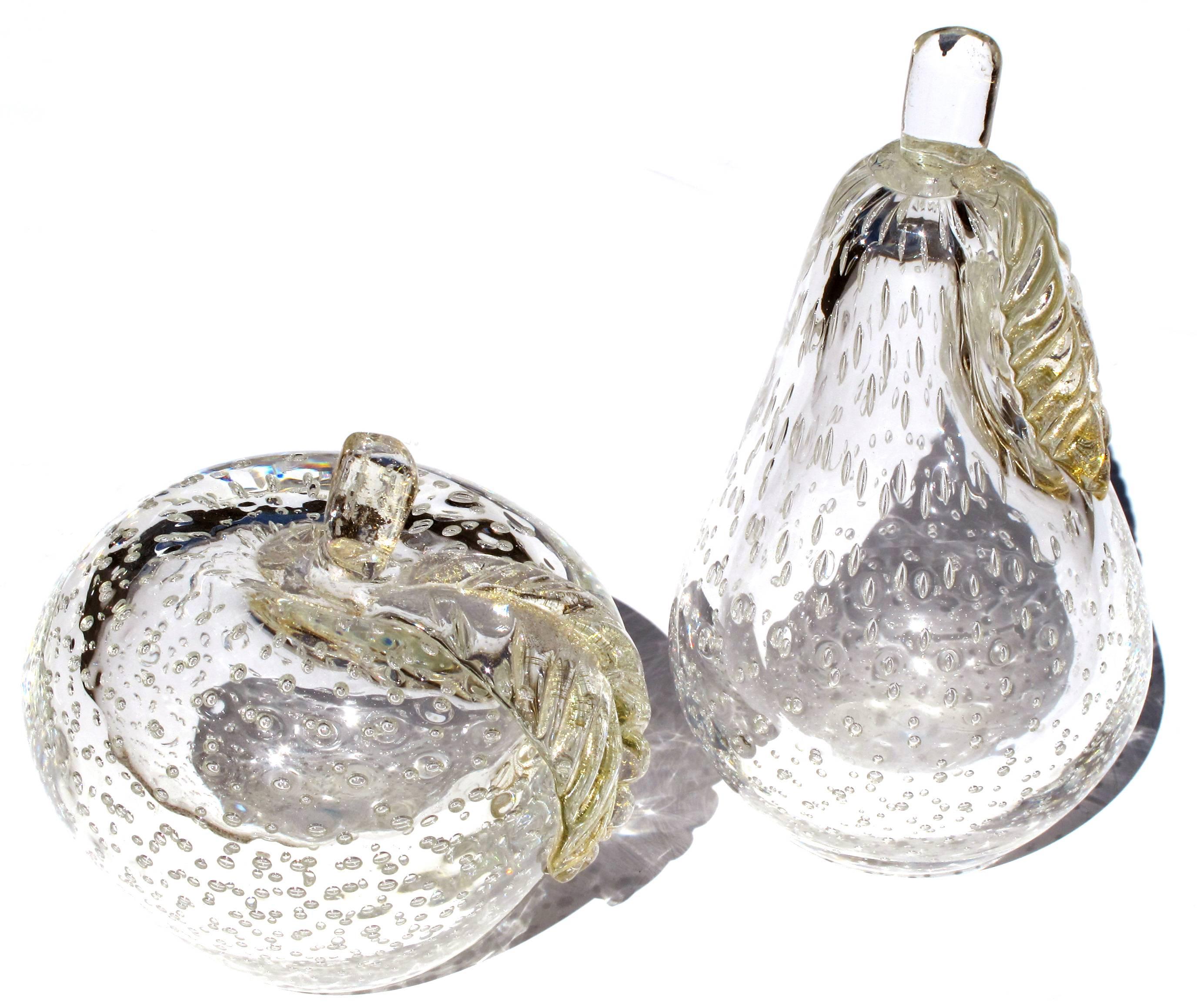 A beautifully crafted and large-scaled Murano 1950's clear art glass bullicante apple and pear with gold inclusions; by Barbini Sommerso; each shapely fruit with stem and leaf above a thickly-modeled body
