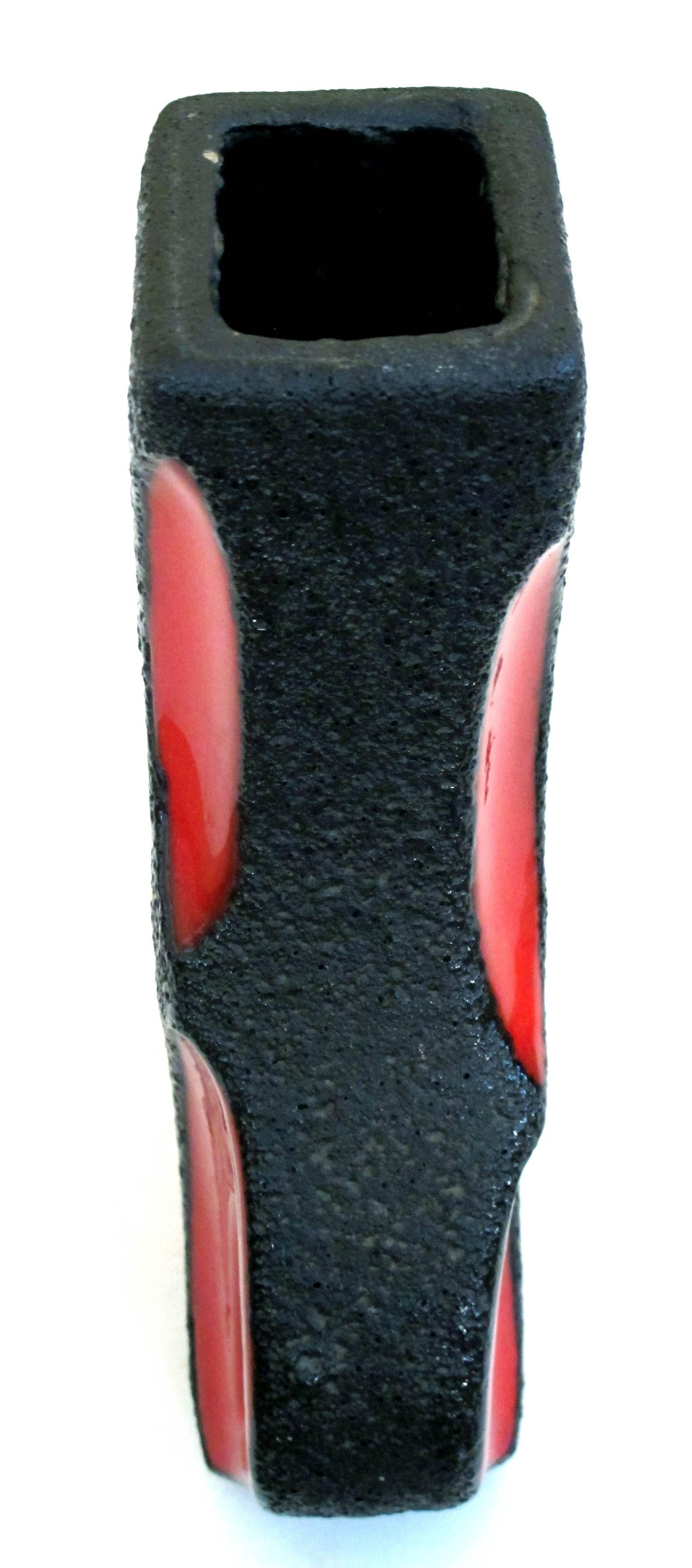 A shapely pair of West German Roth Keramik art pottery 'fat lava' guitar vases with red glaze; each with square mouth above a bulbous body all in a thick lava glaze with red glaze reserves; one with original label.