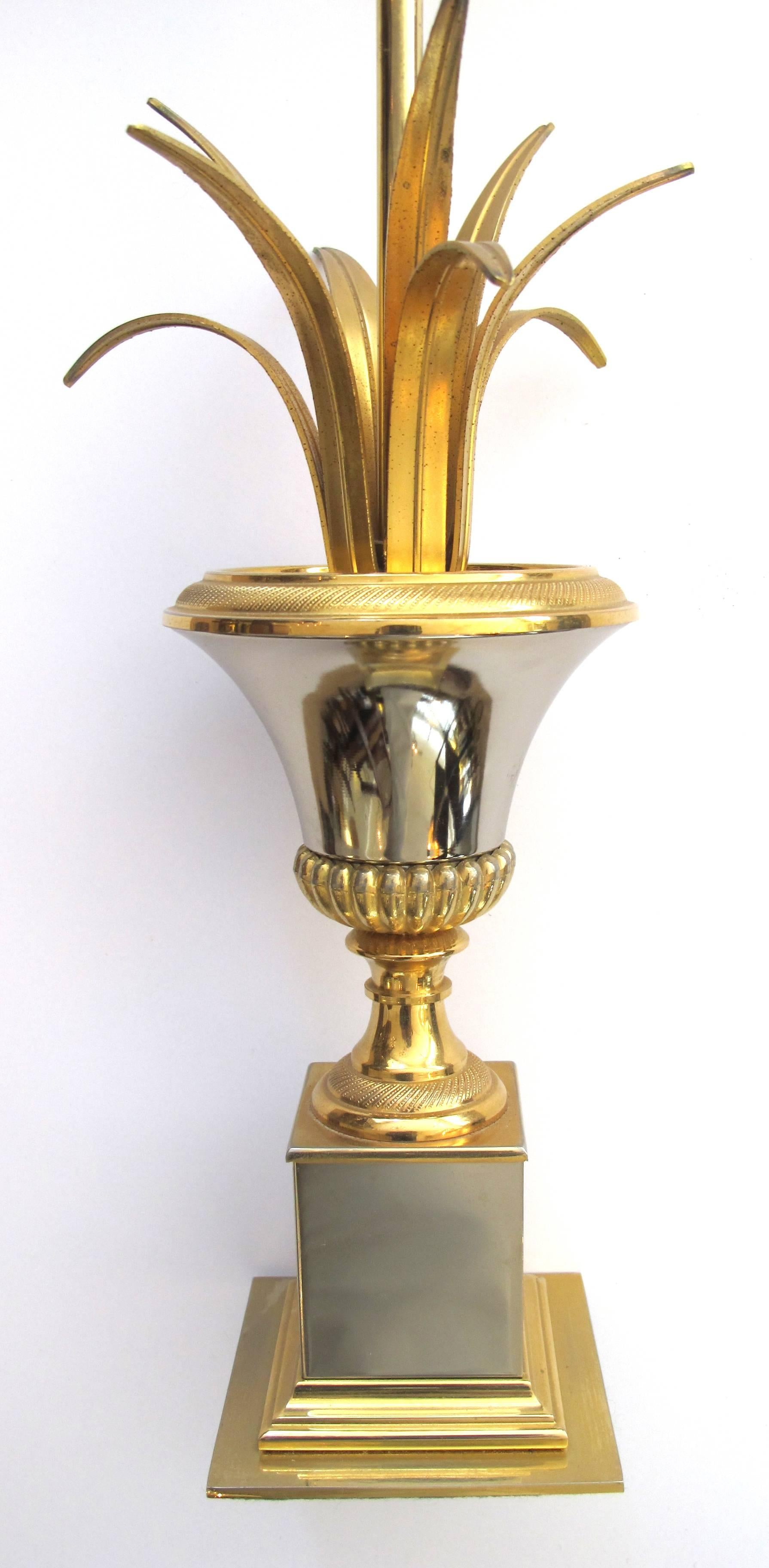 A good quality pair of French 1960s Maison Charles style two-tone brass and steel urn-form lamps; each classically-inspired urn-form lamp with out-scrolled leaves.