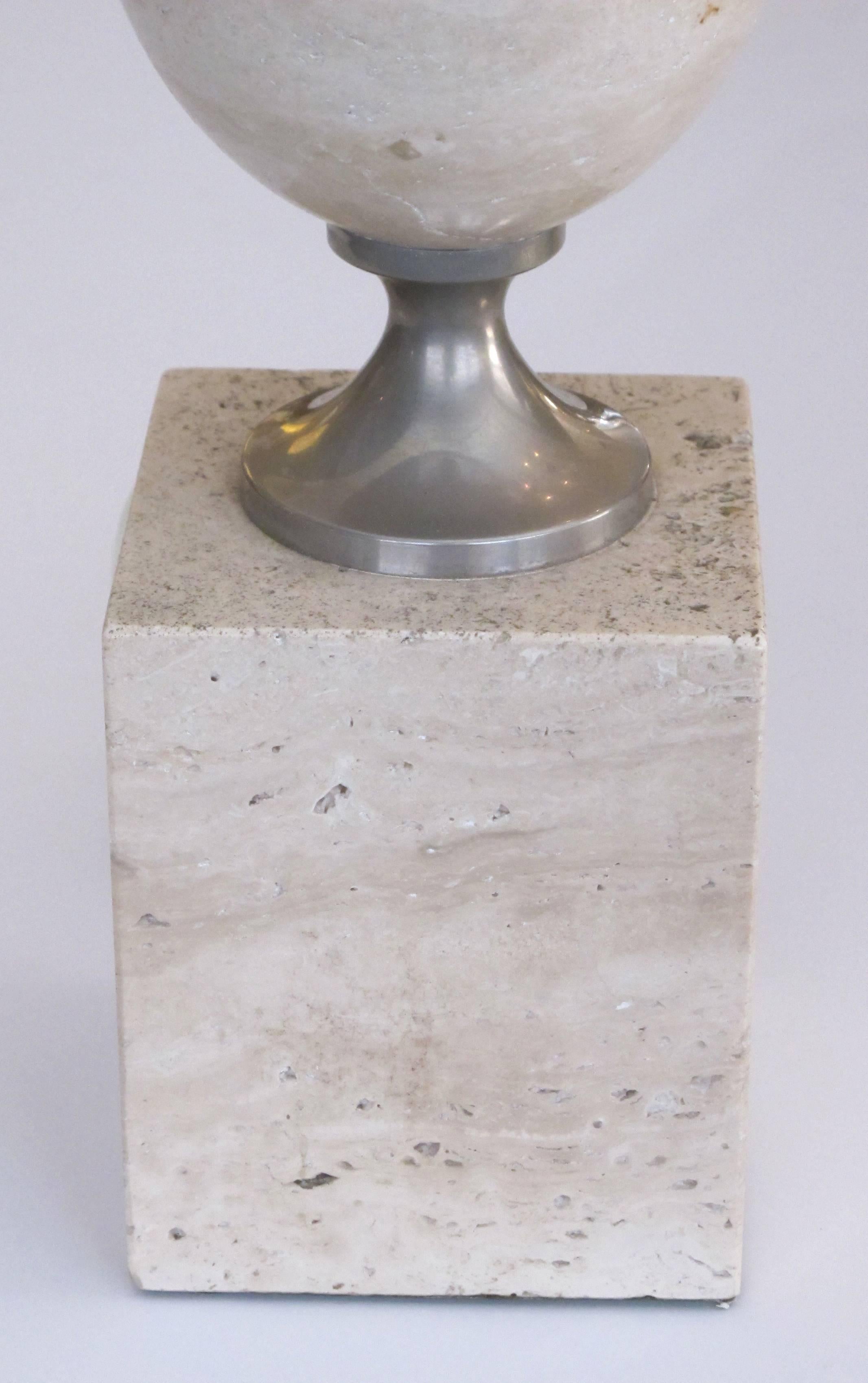 A good French 1970s Philippe Barbier polished travertine and chrome lamp; the ovoid lamp over a square plinth joined by chrome fittings.