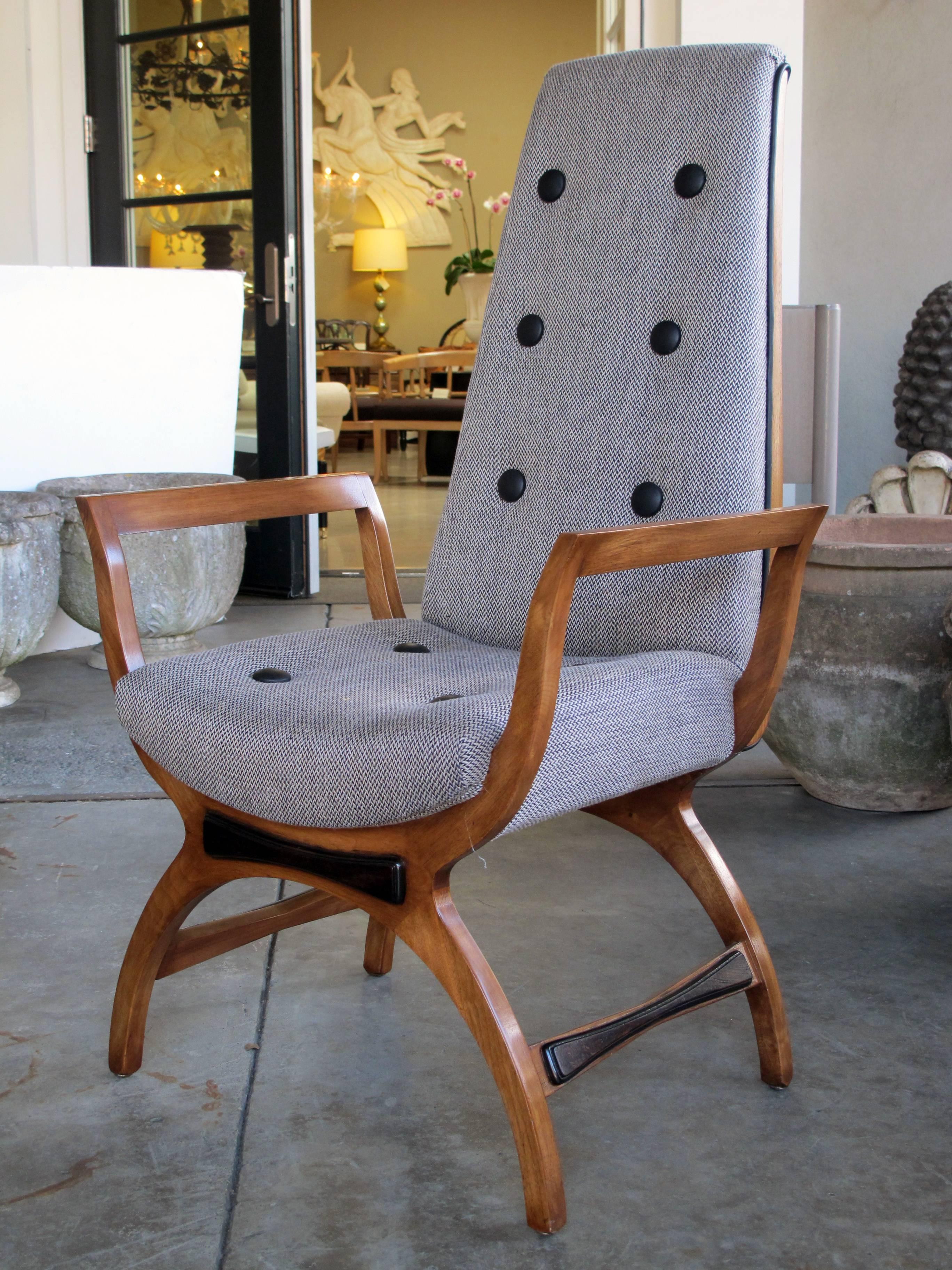 A stylish pair of American, 1960s high-back open-arm lounge chairs in the manner of Adrian Pearsall; each with tall upright back over a saddle seat flanked by out-scrolling open arms; raised on Curule-form supports.
