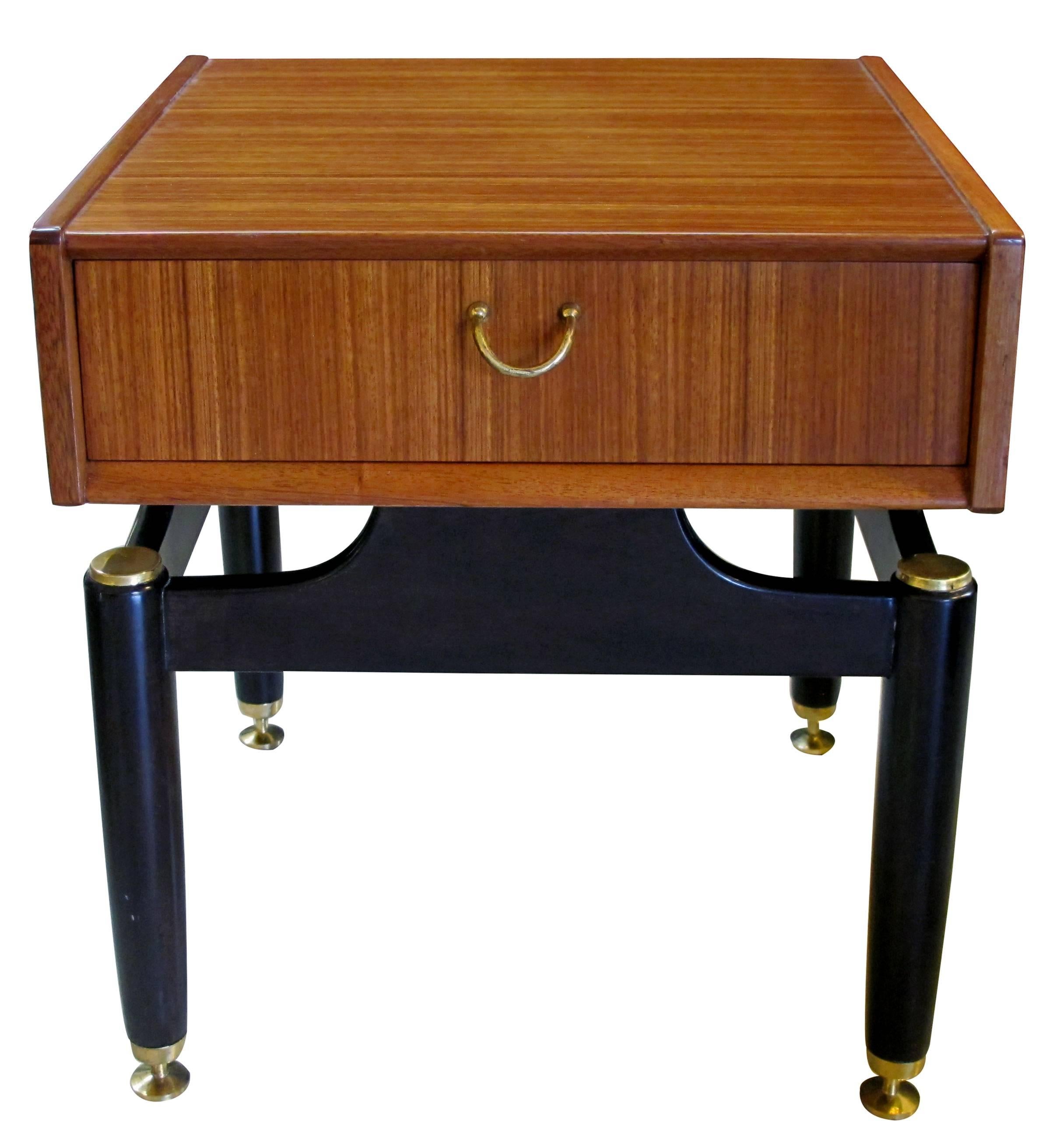 A cool pair of English Mid-Century G-Plan Tola Librezza single-drawer mahogany end/bedside tables; each fitted with a single drawer floating over an ebonized base; stamped with maker's mark.