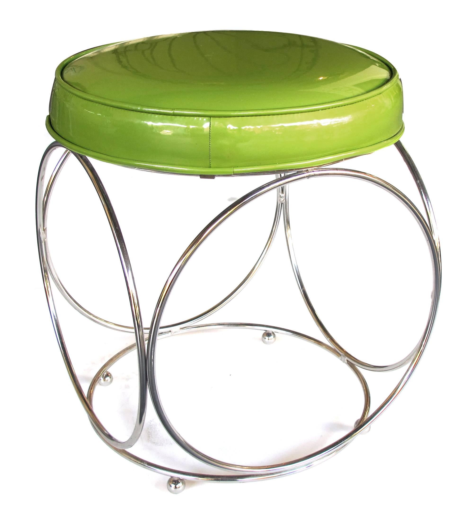 A cool pair of American George Koch & Sons Mid-Century chrome stools with apple-green vinyl seats; each with circular apple-green vinyl seat above an openwork base of five joined chrome tubular rings all raised on spheroid feet.