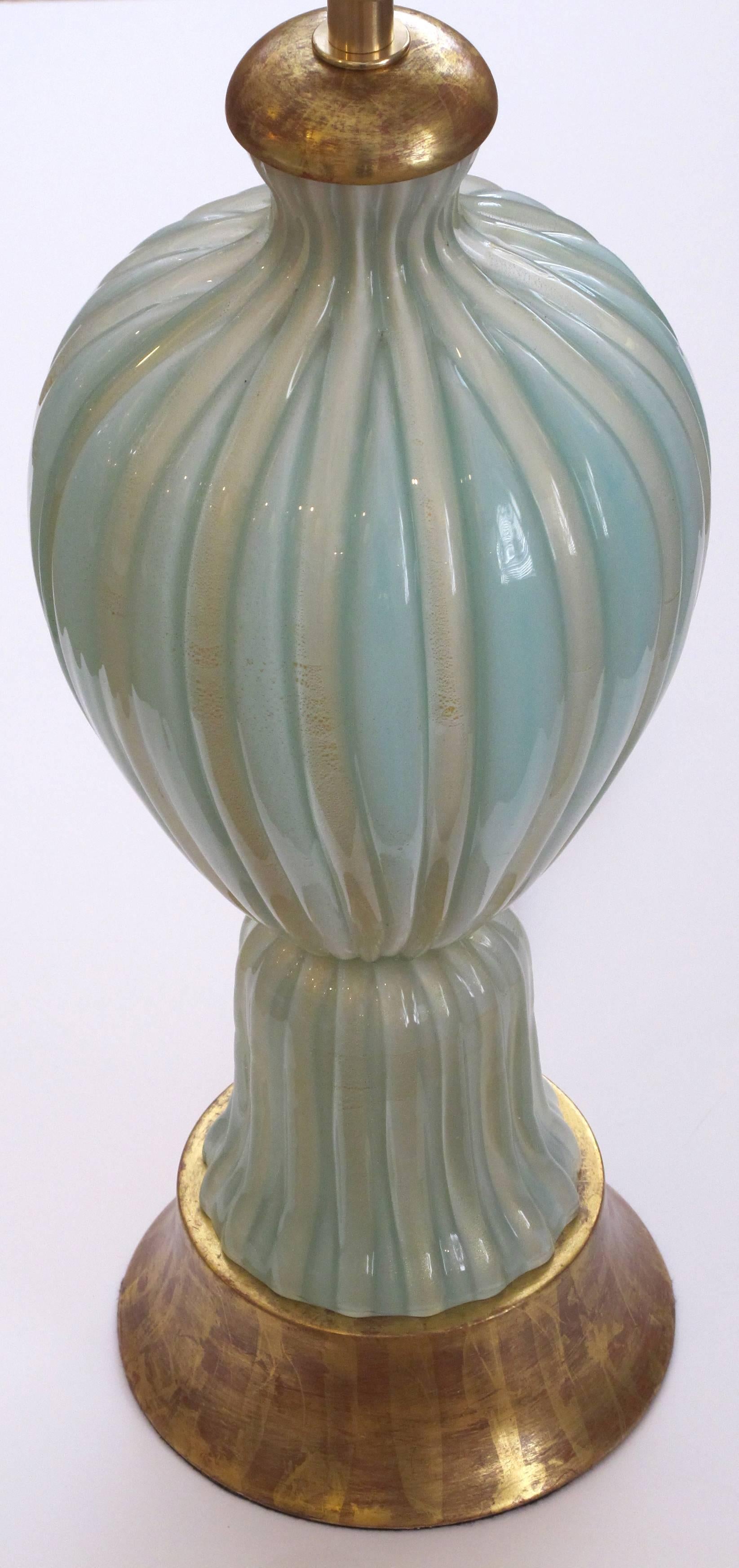 A large and good quality Murano 1950s Barovier & Toso seafoam green lamp; of ribbed ovoid shape with gold venturing inclusions all-over a splayed giltwood base.