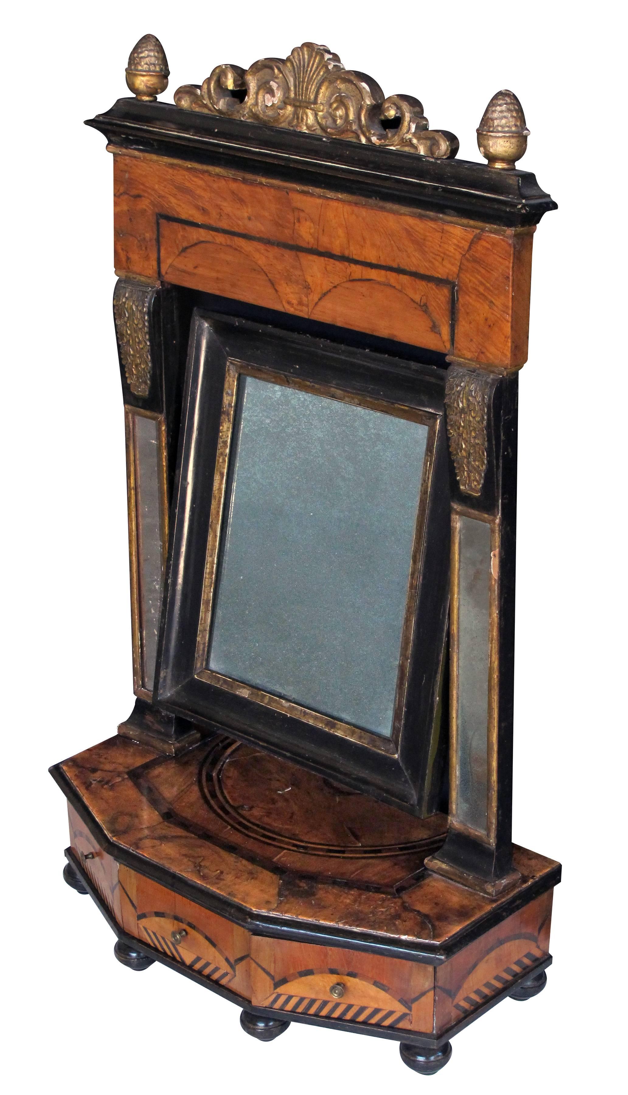 A rare and richly patinated Italian burl walnut inlaid three-drawer dressing mirror; the original hinged plate flanked by mirrored stiles above a rectangular canted body fitted with three drawers; great for a man's dressing room for cufflinks,