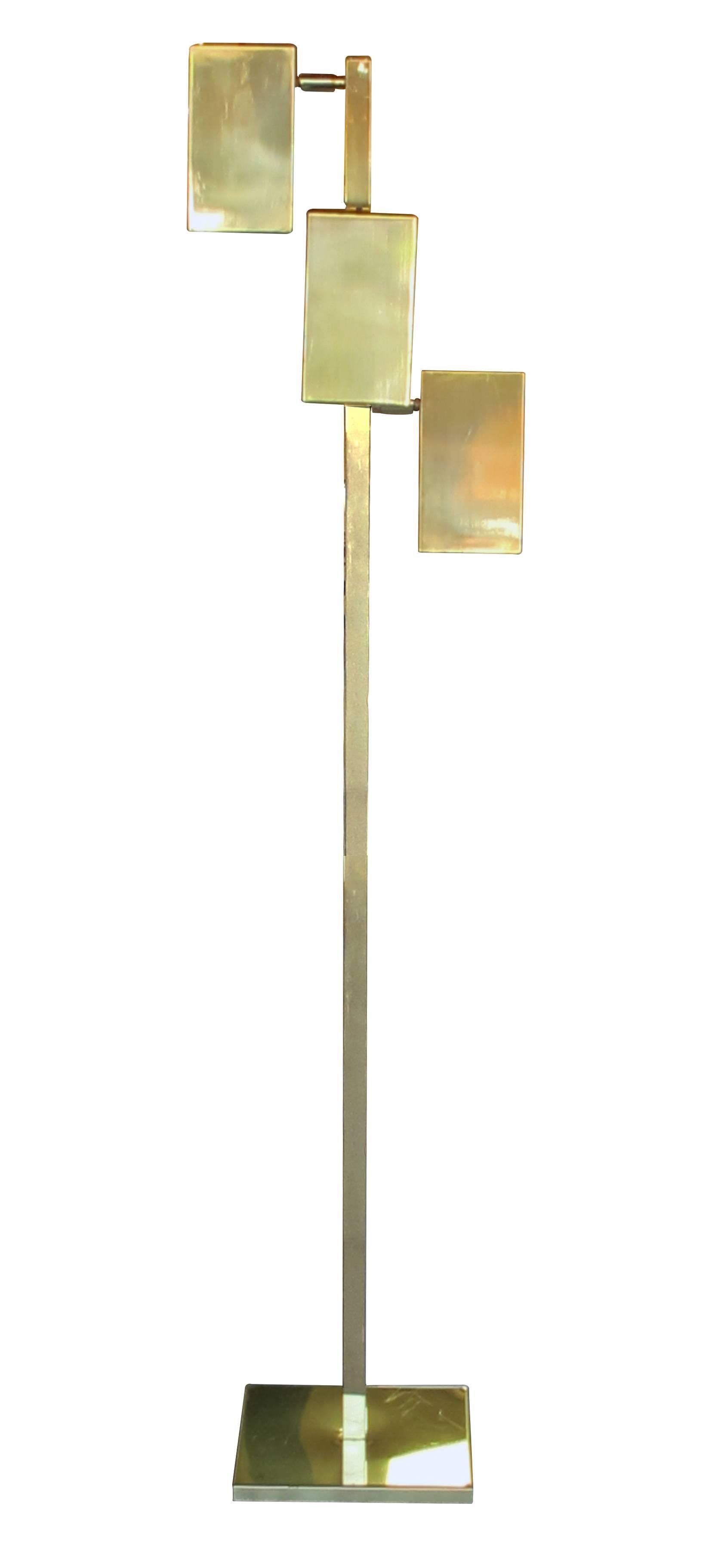 A sleek American 'Koch & Lowy' three-light brass floor lamp; with three adjustable rectilinear shades that swivel and tilt to control the light; each light with separate switch; stamped 'KOCH & LOWY'; with and depth varies depending on shade