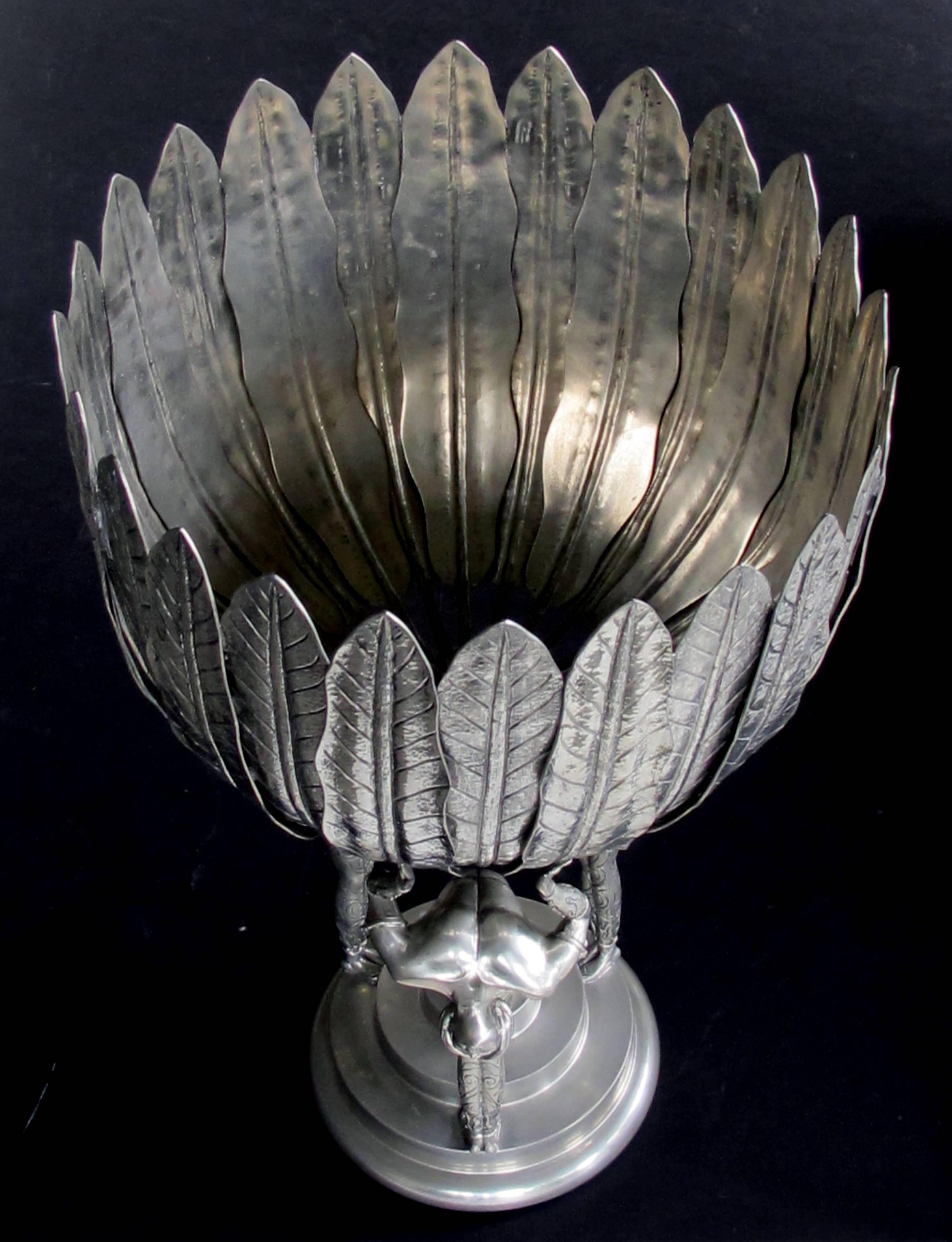 A stunningly large Italian Art Deco style Piero Figura pewter centerpiece stamped 'Figura Piero per Atena, Etain 95%'; this finely executed, large and heavy centerpiece depicting three costumed male acrobats standing on a circular stepped base, each