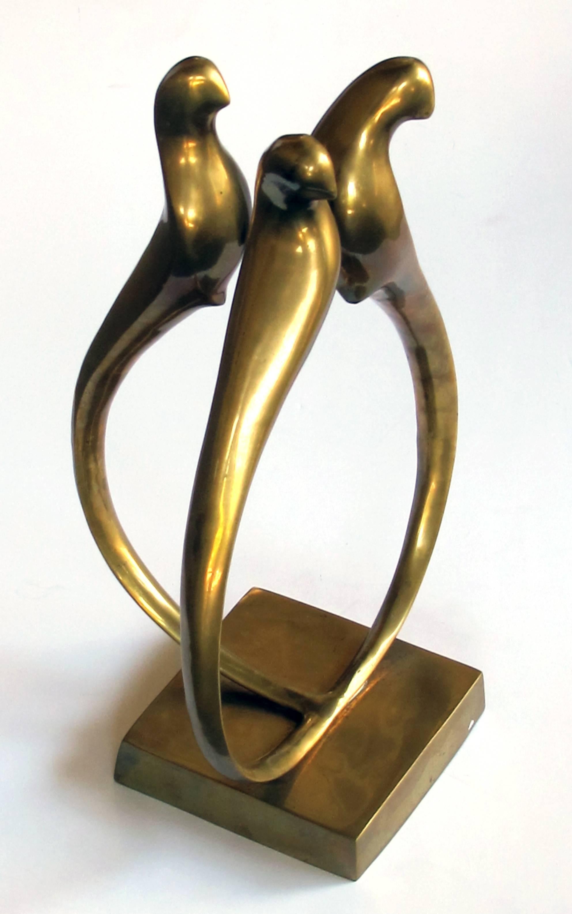 An elegant modeled Italian 1960s brass sculpture of three stylized birds with long tails; the shapely figure depicting three clustered birds with expressively-turned heads above long sweeping tails.