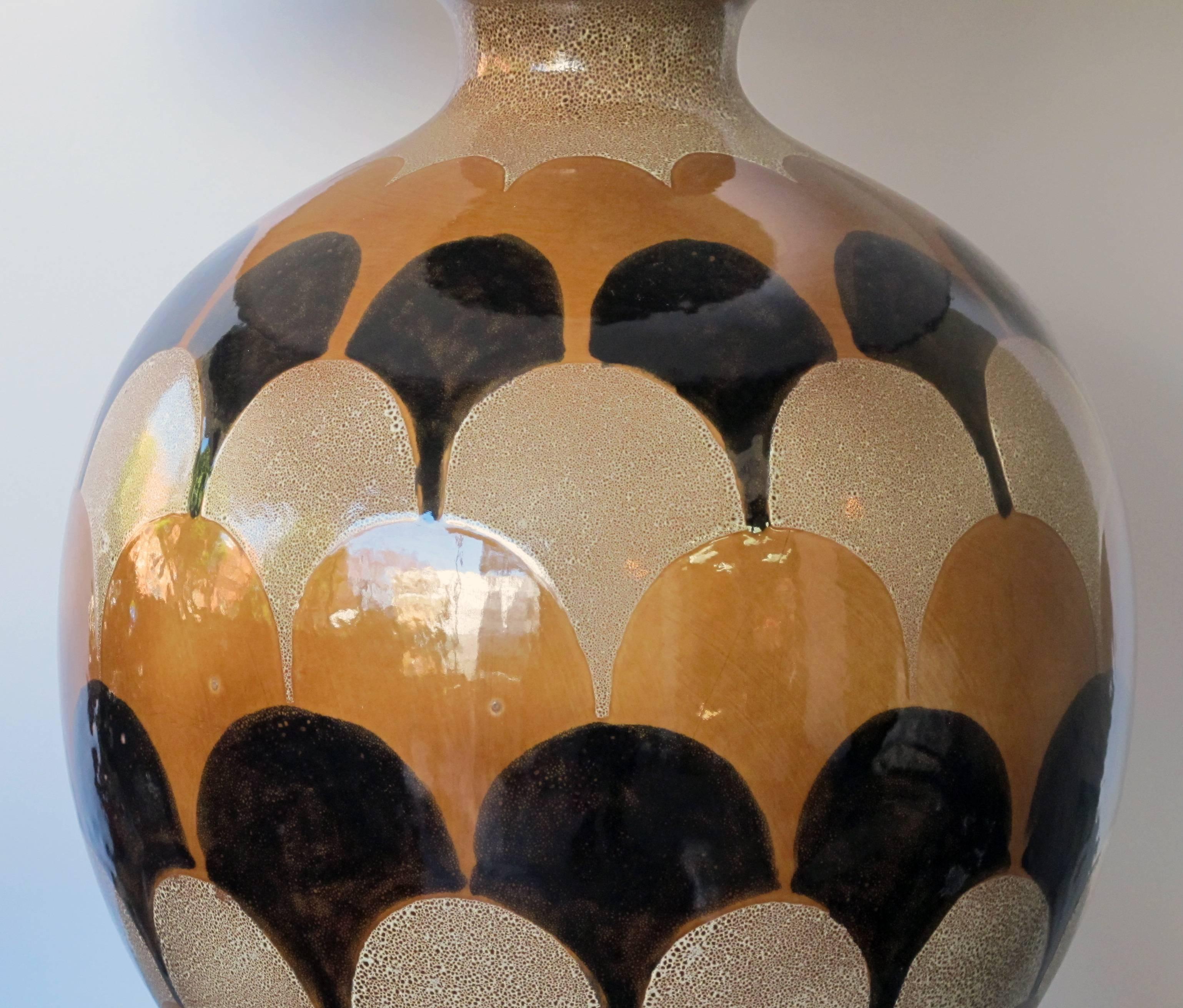 A bold pair of Italian 1970s handmade ovoid-shaped ceramic lamps with imbricating glaze; each large lamp glazed in an overlapping glaze in muted tones of ivory, russet and black.