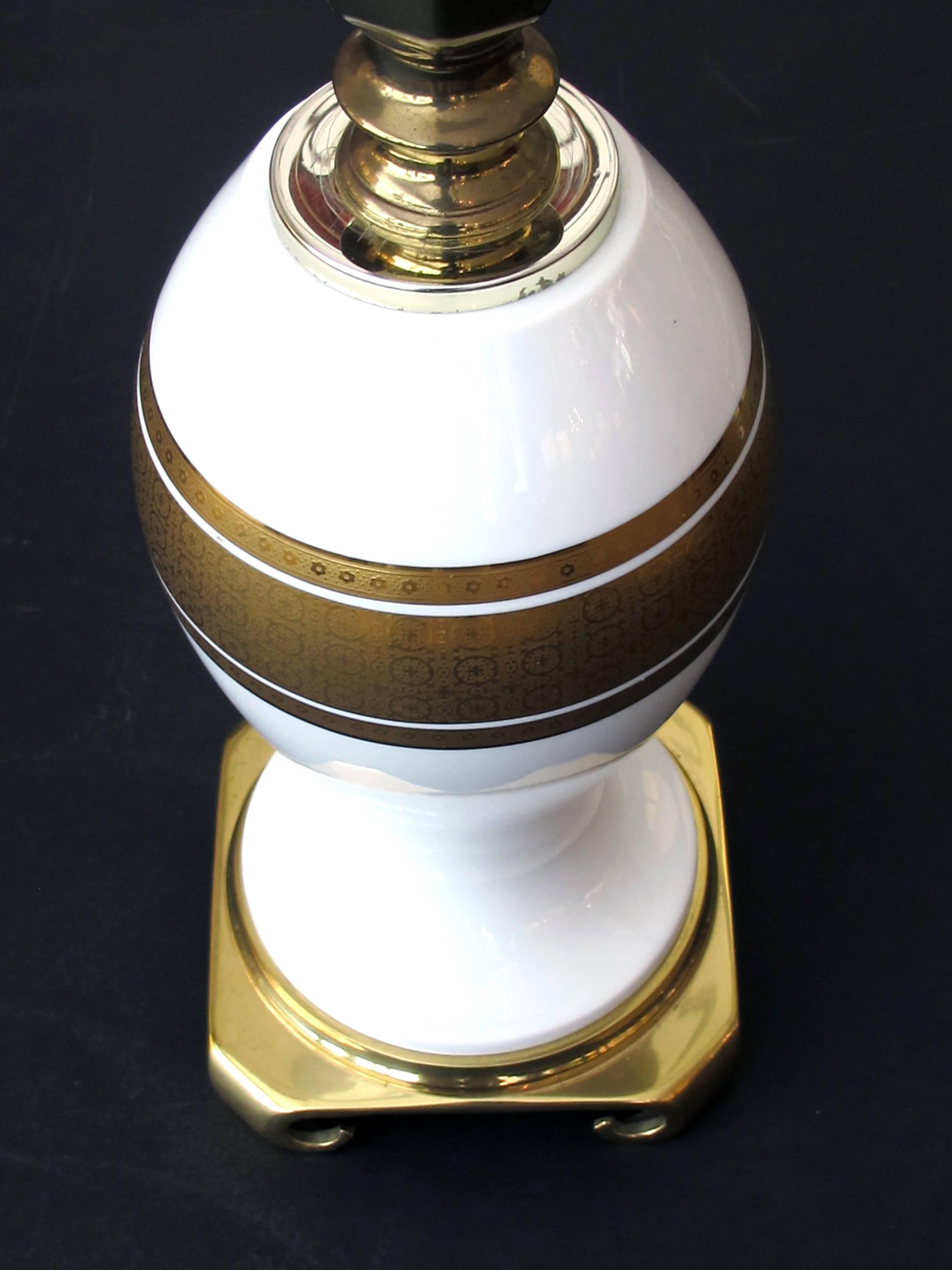 Each bulbous urn with gilt perimeter bands with raised decoration on a luminous white ground.