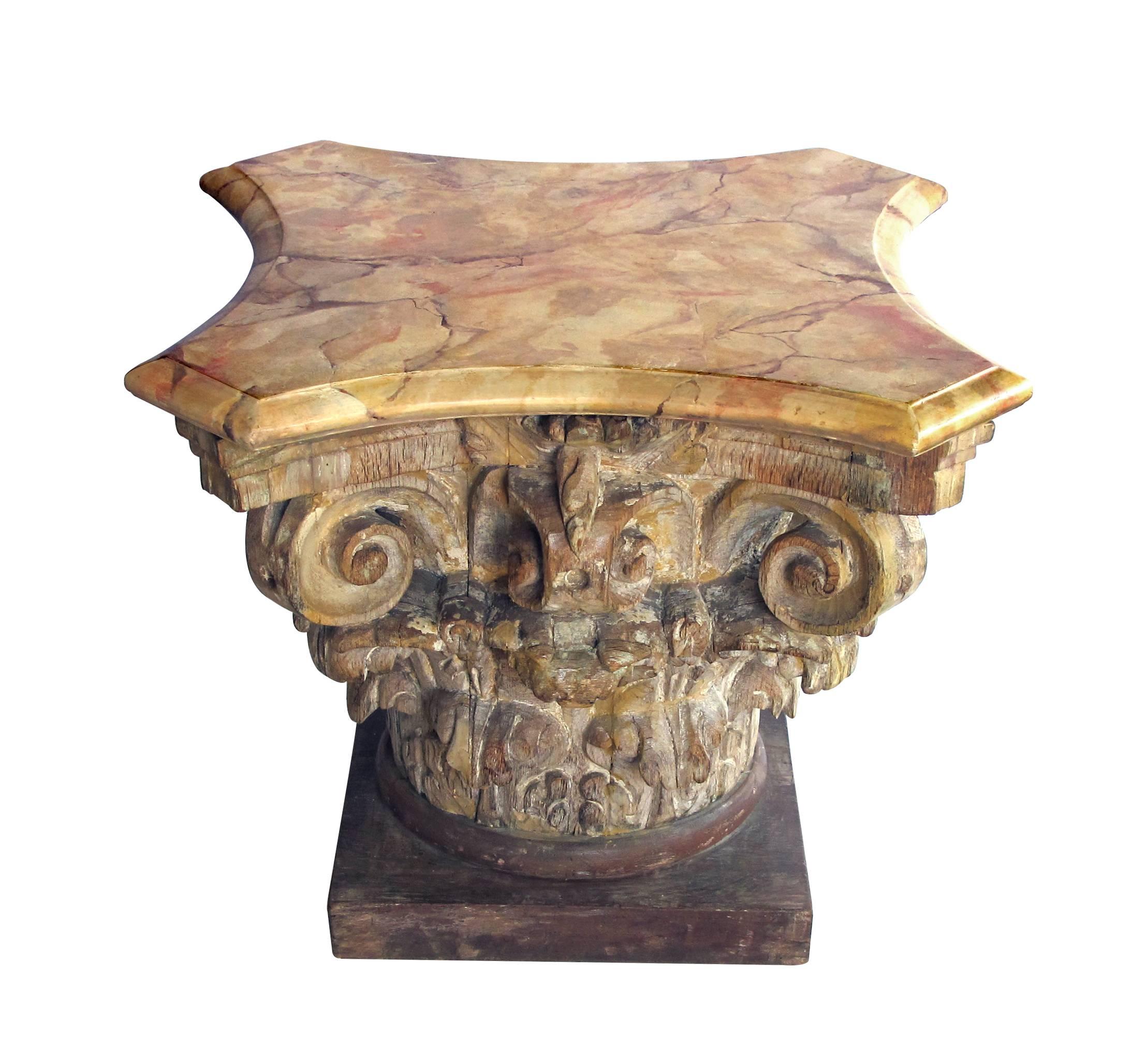 From the Tony Duquette collection, well-carved Italian neoclassical Corinthian capital with faux marble top; the exuberantly carved Corinthian capital with faux marble top; would make a great side table with a piece of glass or as is; remnants of