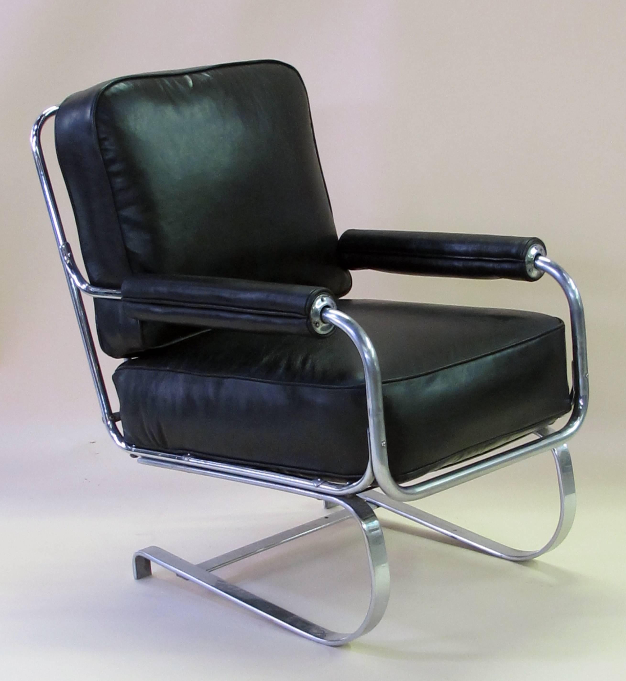 A stylish and rare pair of American 1930s Machine Age tubular chrome springer armchairs by KEM Weber for Lloyd Manufacturing; with cantilever, tubular chromed steel frame with padded armrests and new charcoal leather upholstery.