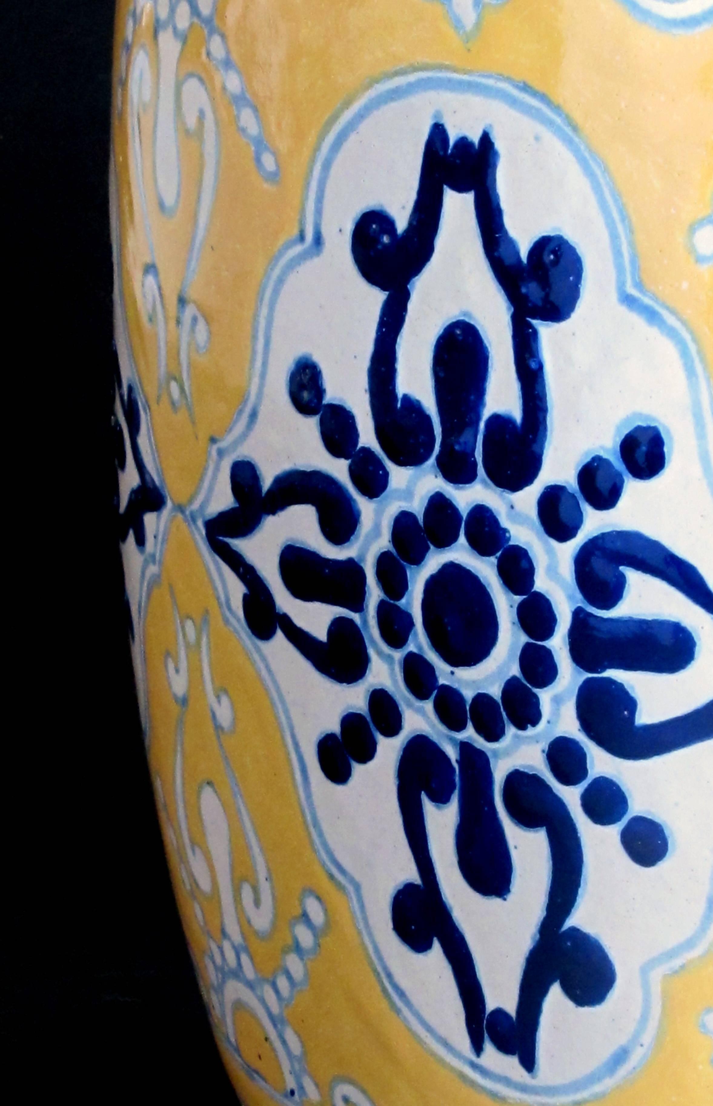 A large and good quality Mexican mustard glazed barrel-form pot with cobalt blue decoration; underside with maker's mark 'Uriarte Talavera Pue. Mex'; from the collection of a notable Napa interior designer for his hacienda in La Penita de Jaltemba,
