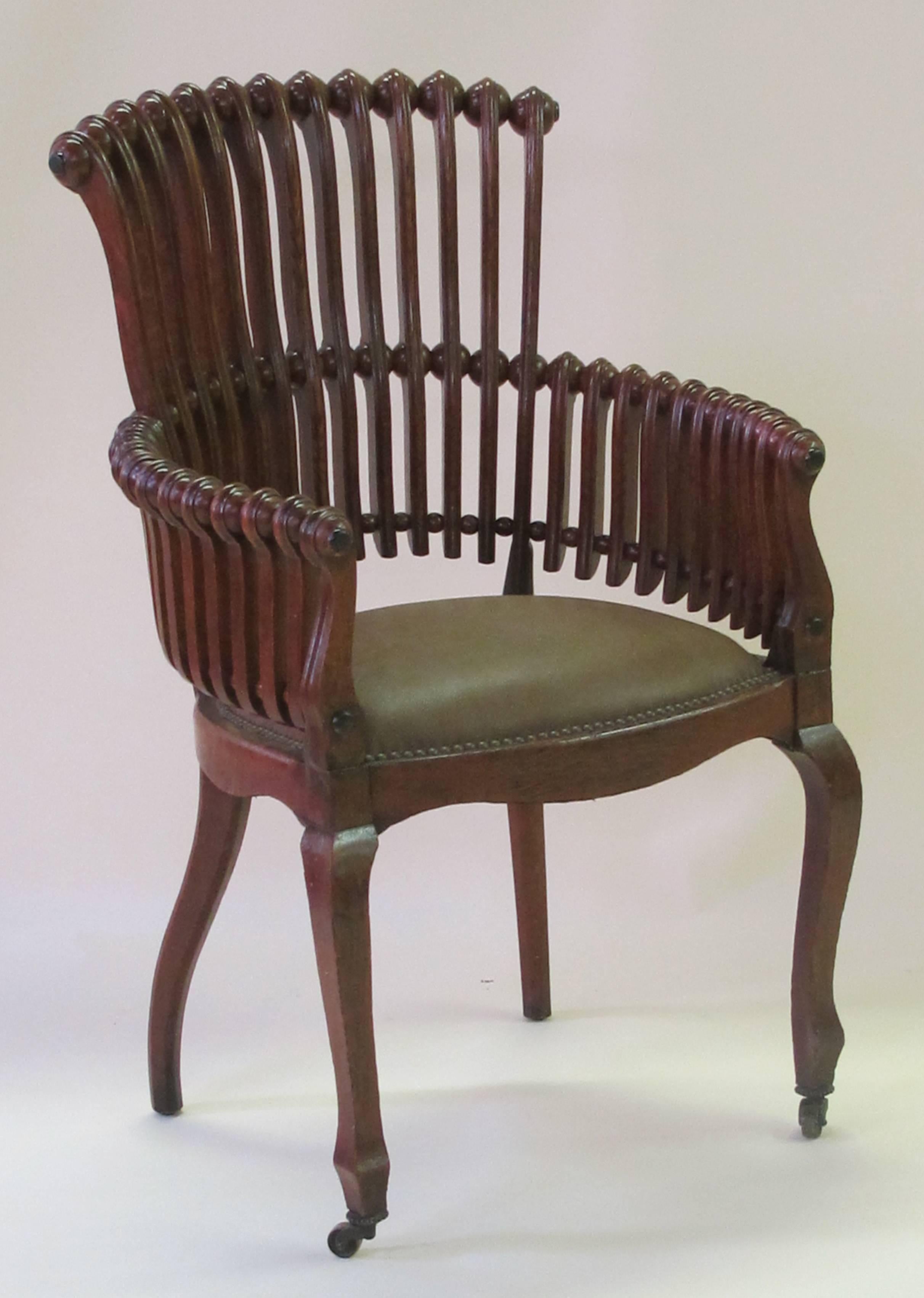 An iconic American aesthetic movement oak 'lollipop' arm chair by George Hunzinger (1835-1898); this well-crafted chair consisting of carved spheres mounted on spindles mimicking a child's candy sucker; new leather seat; the furniture of George