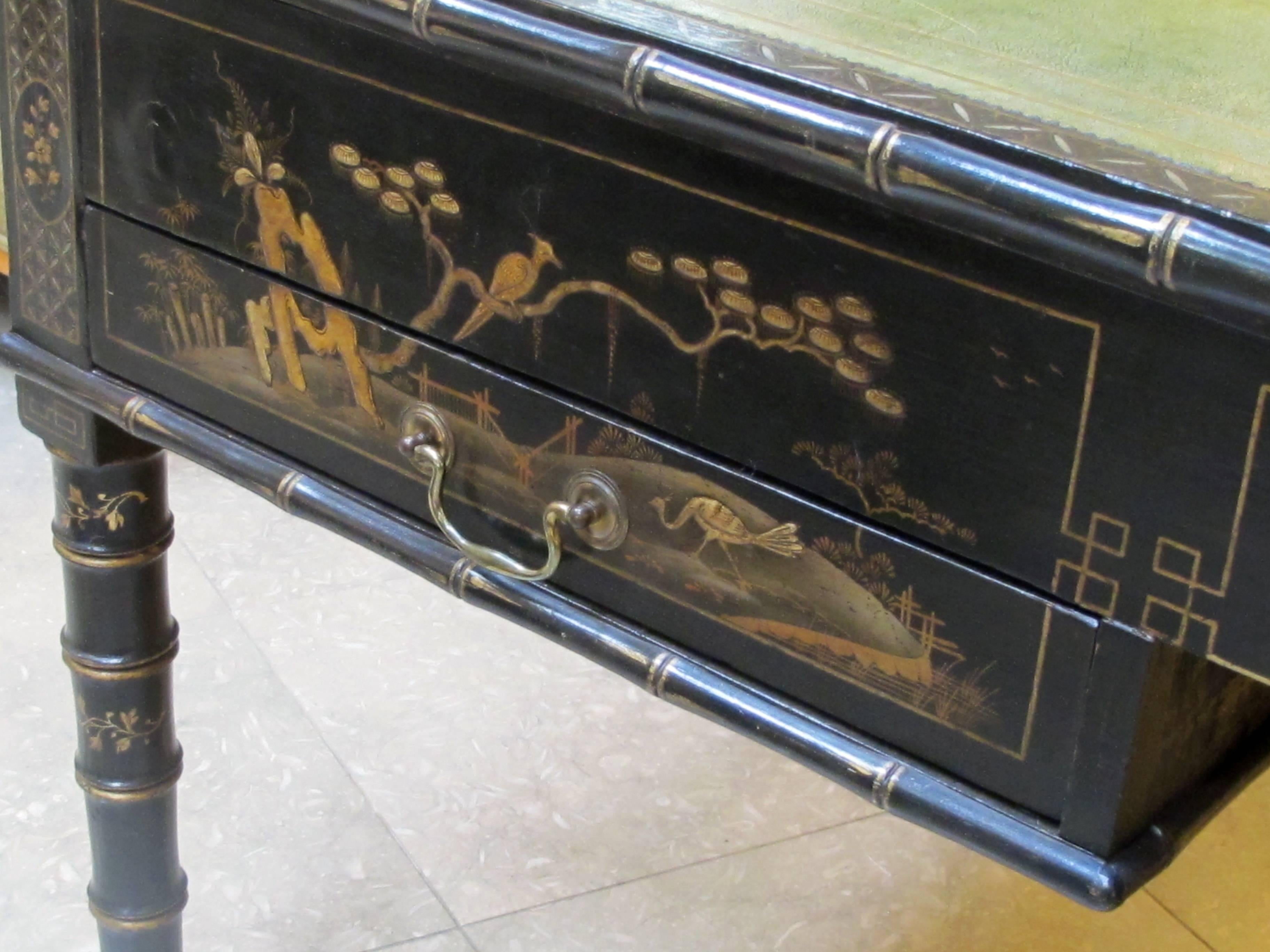 A rare English regency style japanned map table now adapted to a reverse partners desk; ex-collection Michael Taylor, San Francisco; the rectangular inset olive green leather writing surface decorated with gilt tooling above an apron fitted with two