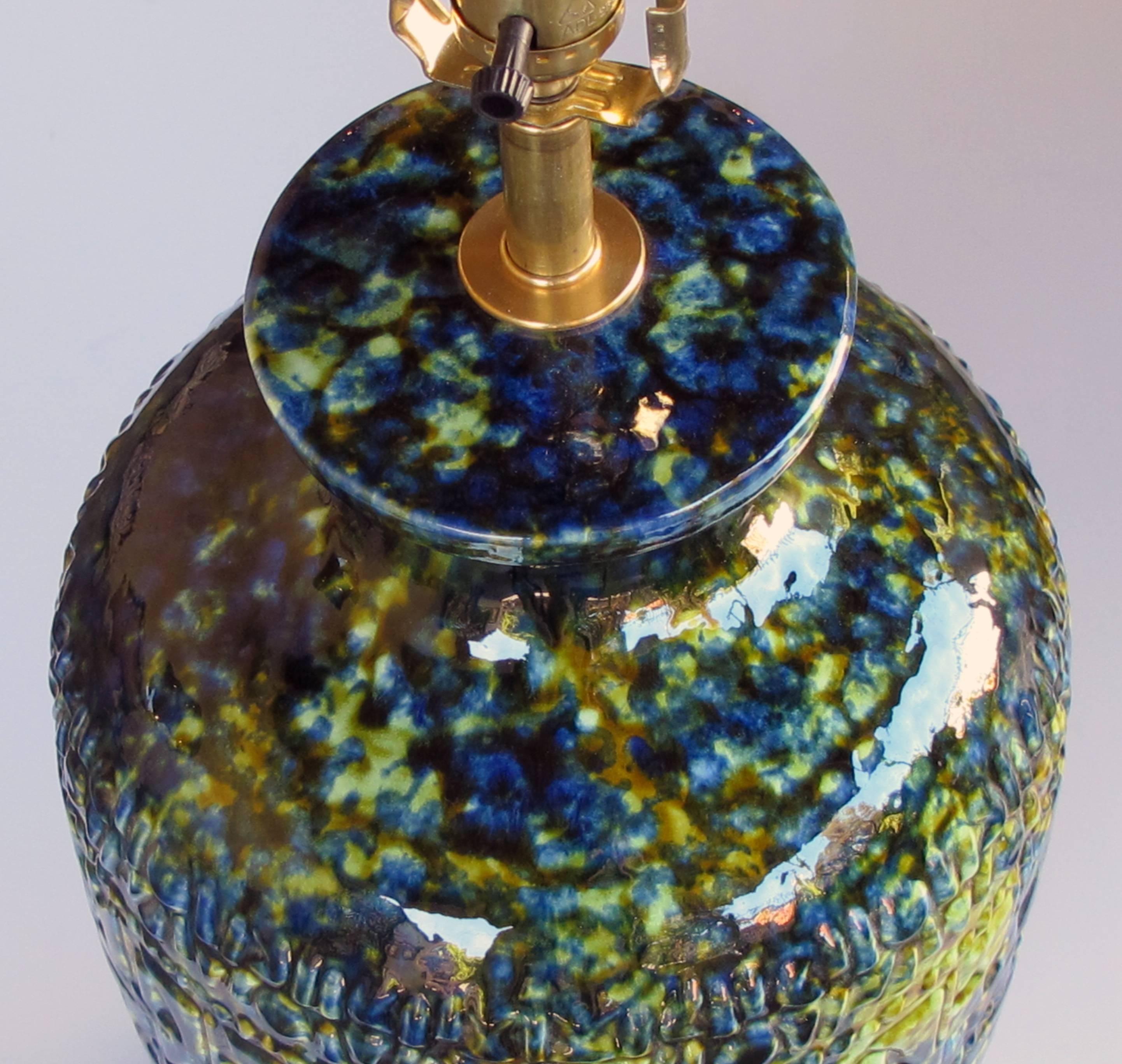 A massive and richly-colored pair of American 1960s ceramic lamps with blue, green and yellow drip glaze; each of super good quality and great scale, jar-form lamp with textured surface decorated with a luscious drip glaze raised on matte black