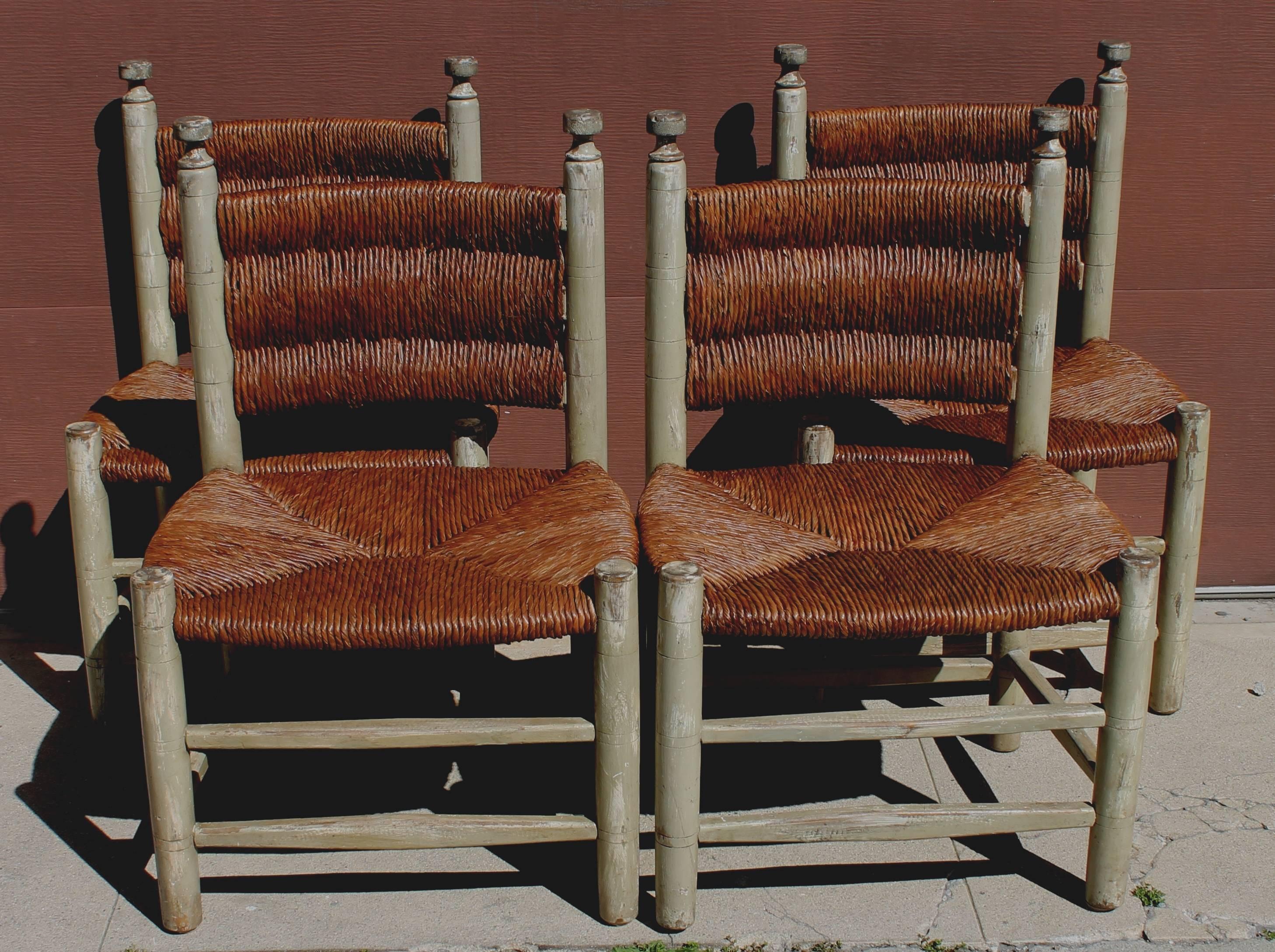 Set of four barrel back rush chairs in great condition. These four super comfortable original worn surface rush seat and back chairs. The condition is very strong and sturdy. The painted surface is worn with a fantastic patina.