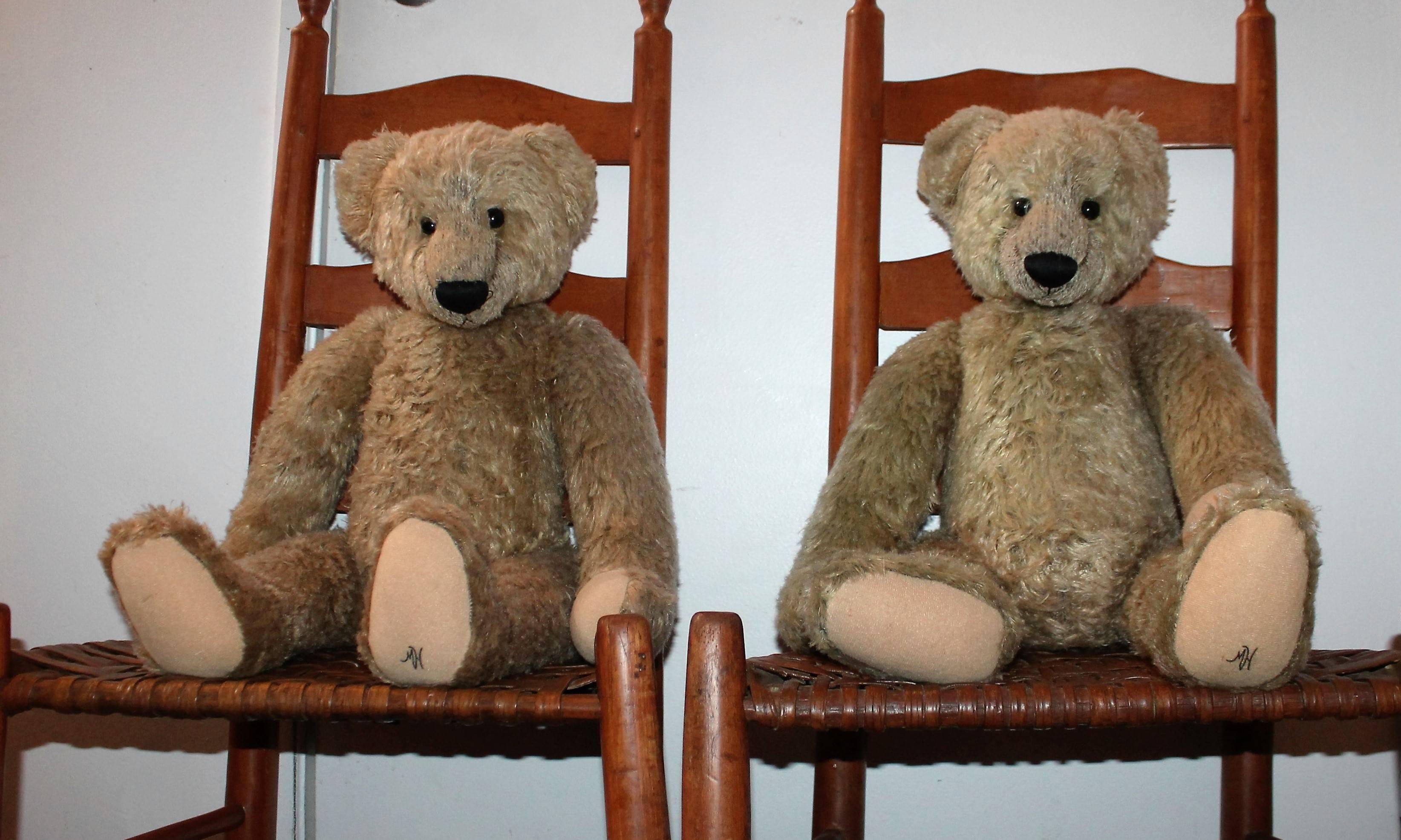 This pair of jointed hump back bear are in good condition with wear consistent with and use. The bears are signed on their front left foot with a M.H. Made by Merrythought Ltd. for Harrods of London, England. One bear is more faded that the other.