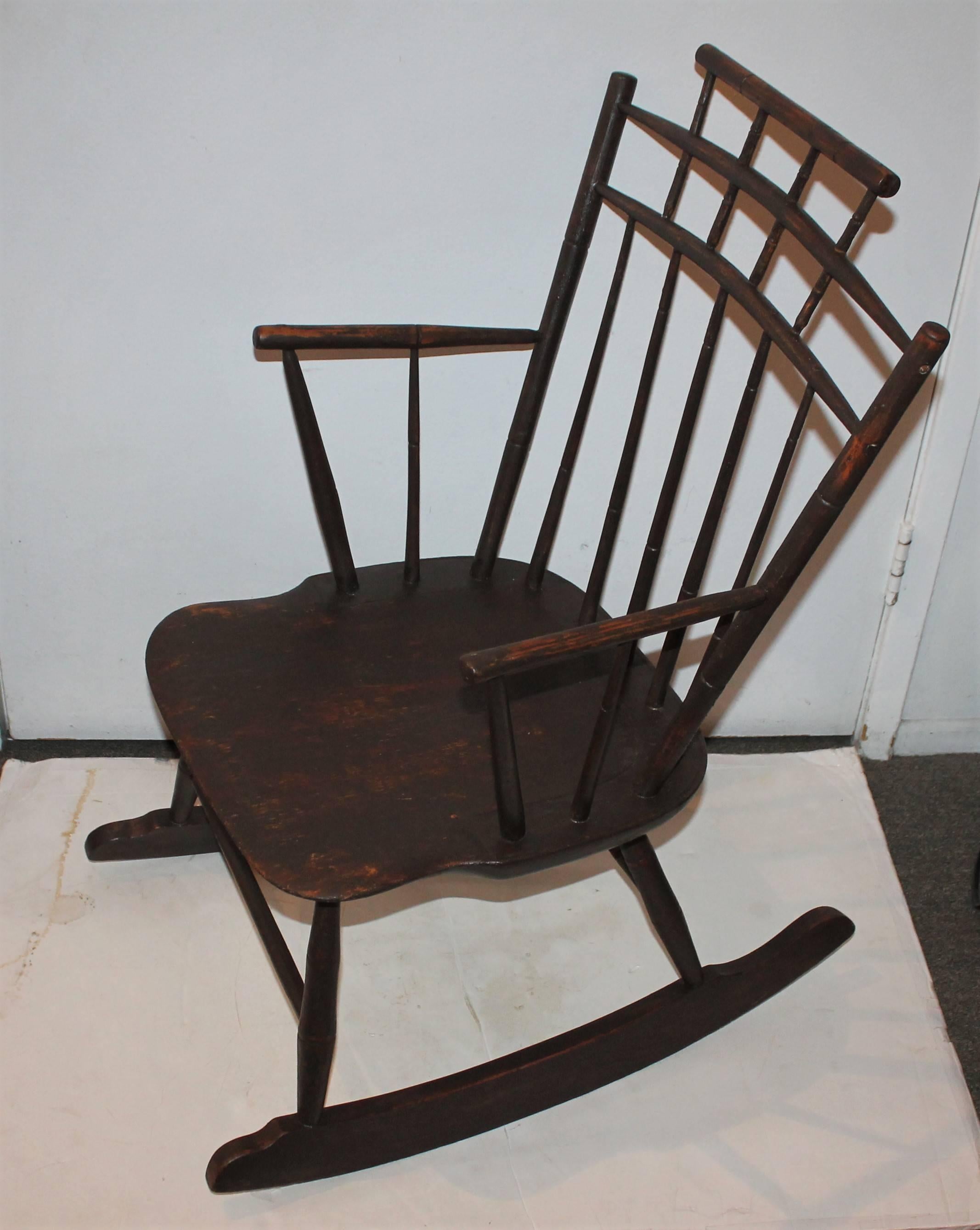 19th century high back windsor rocker has bamboo turnings and has a brown painted surface. The condition is very good.