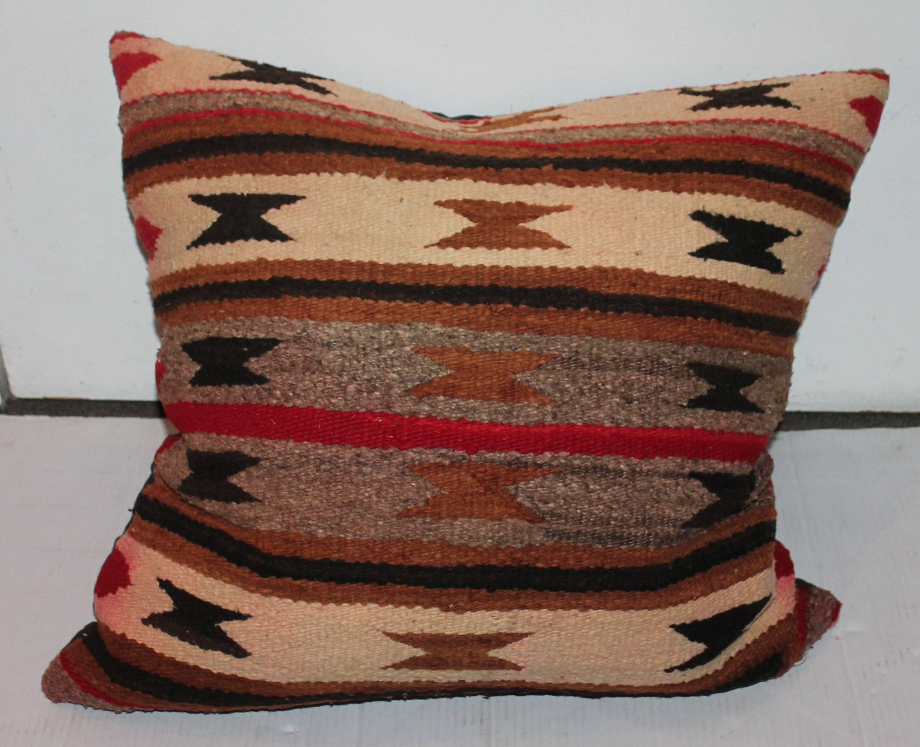 This large hand woven Indian weaving pillow is in good condition with minor bleeding from age and use. The backing is in a black cotton linen.