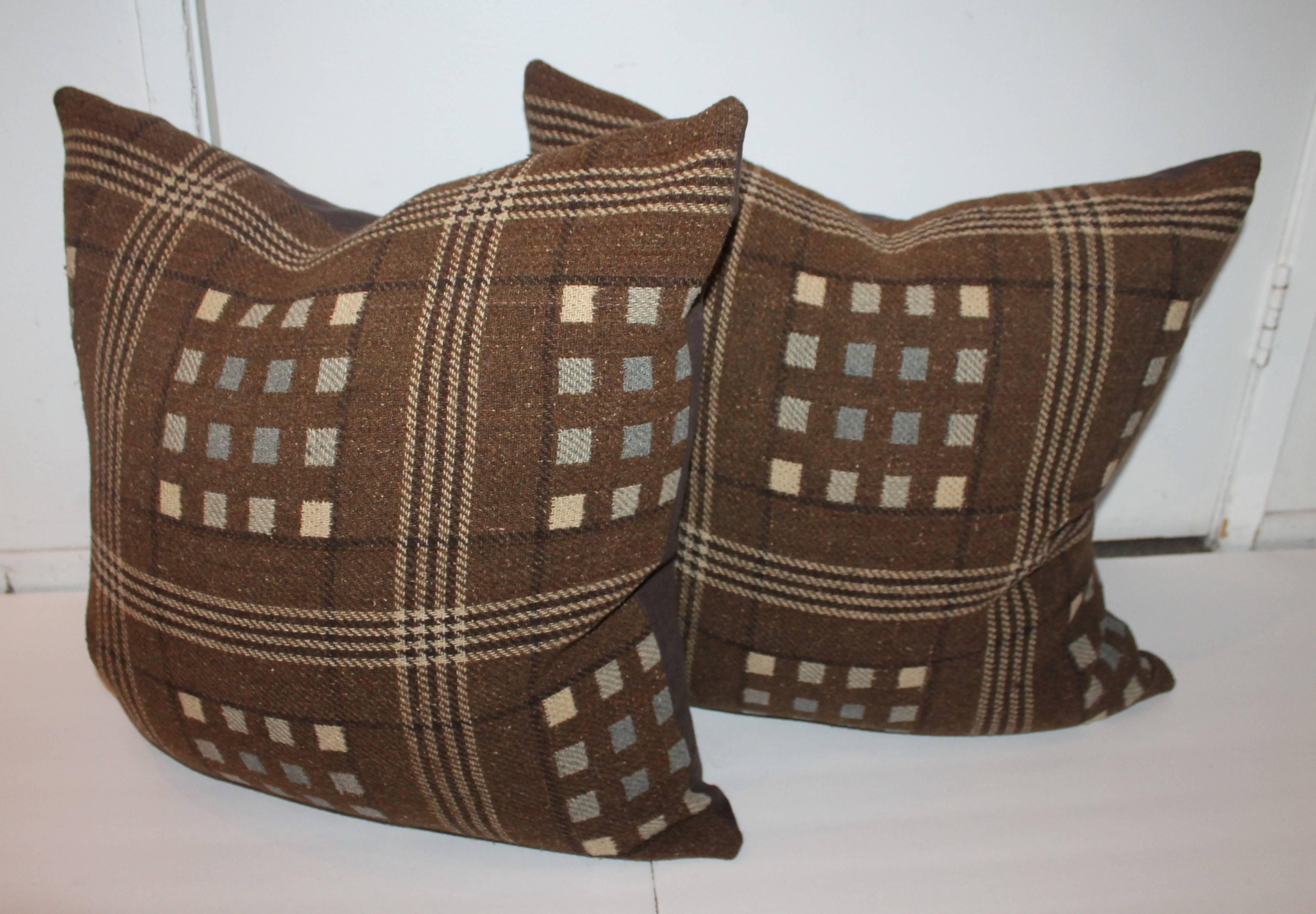 Pair of horse blanket pillows with linen backing, down and feather insert and zipper closure on bottom.