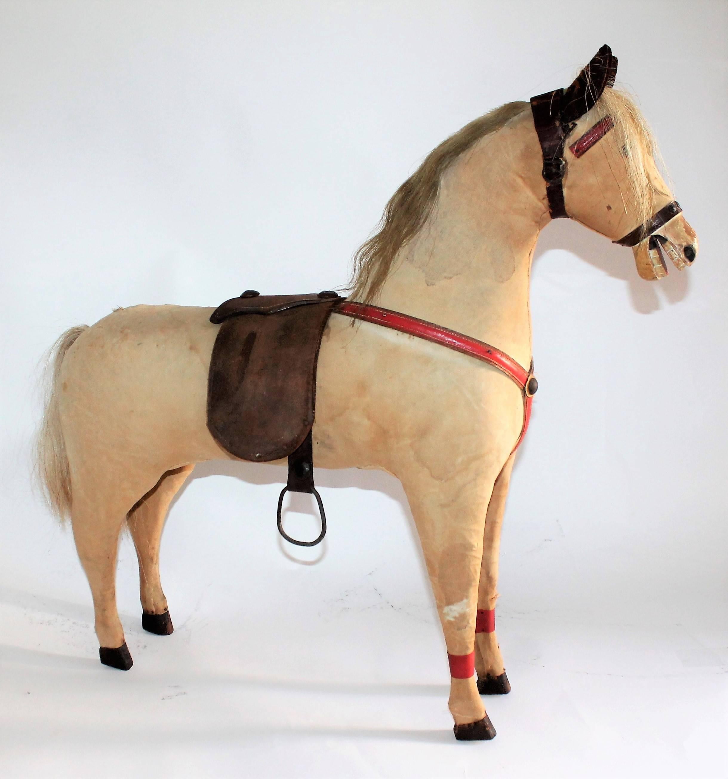 This fine example of Folk Art horse is from a huge monumental rocking horse with out the big rockers from the base. We like it better with out as it is more folky and a great Primitive presents. This horse is covered by the original canvas and