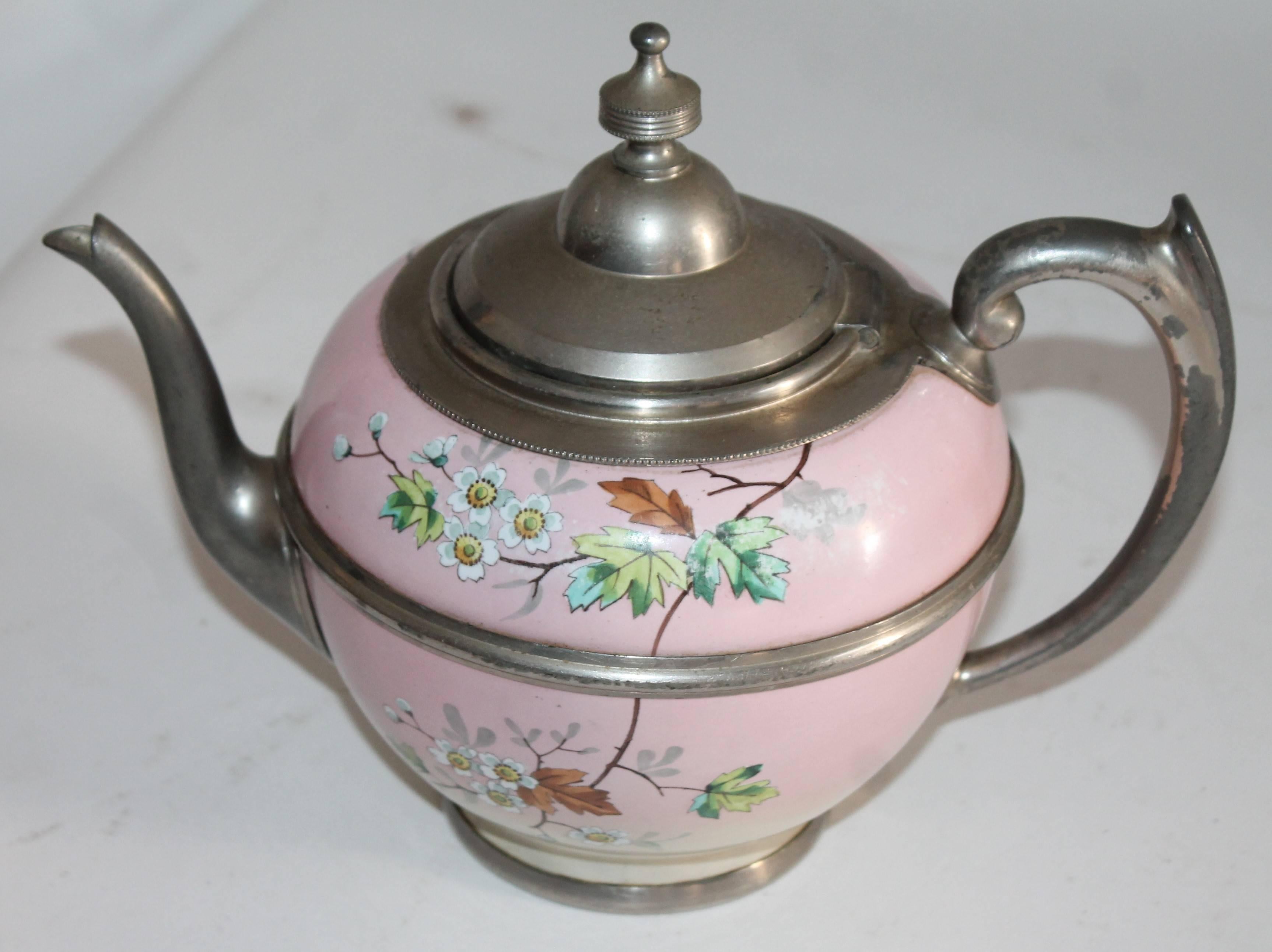This early and quite beautiful hand-painted enamelware coffee pot is trimmed in pewter and in pristine condition. It was in a private collection and we believe it to be English.