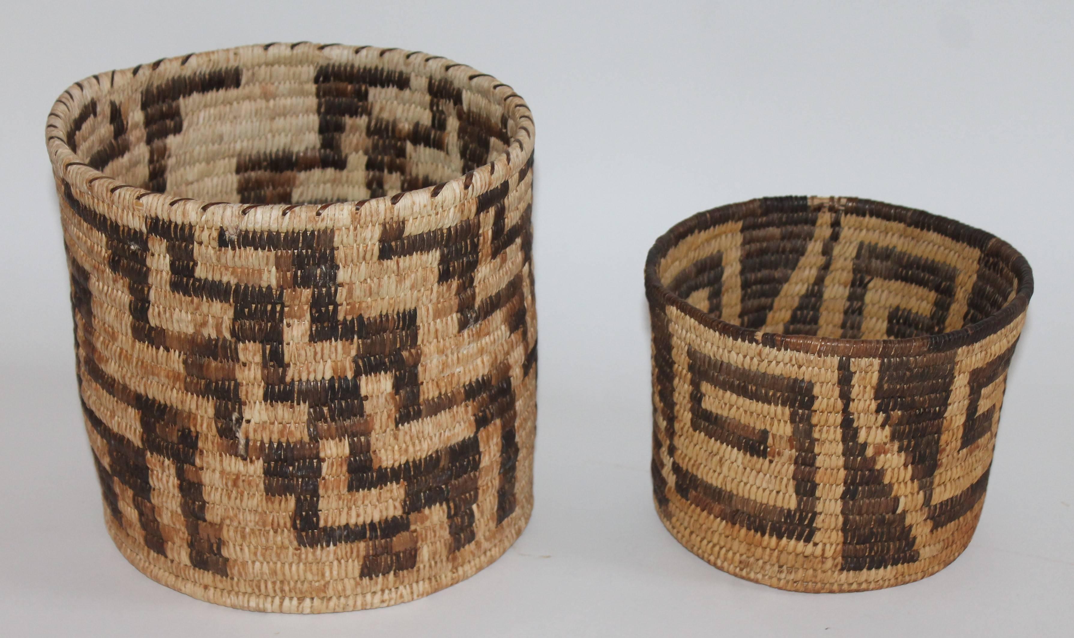 These two Indian baskets are in great as found condition and have a wonderful aged patina. One is tall and measures: 8.5 high x 8.5 and the small geometric 5.5 high x 7 diameter.