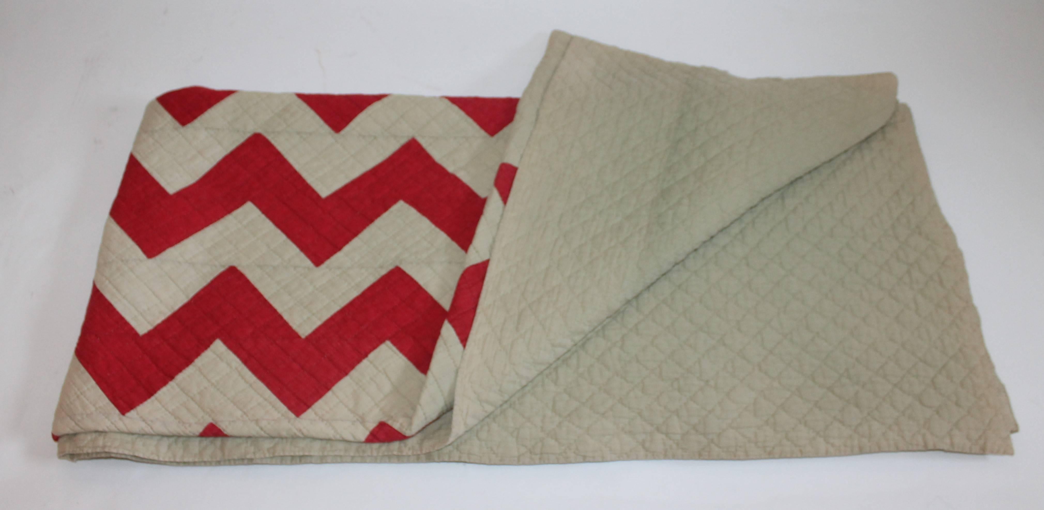 This cactus green and cherry red zigzag quilt is in cotton and tight quilting. The green is overall light and the red is quite sharp. This quilt was found in Ohio but has a great southwest look to it. Condition is very good.