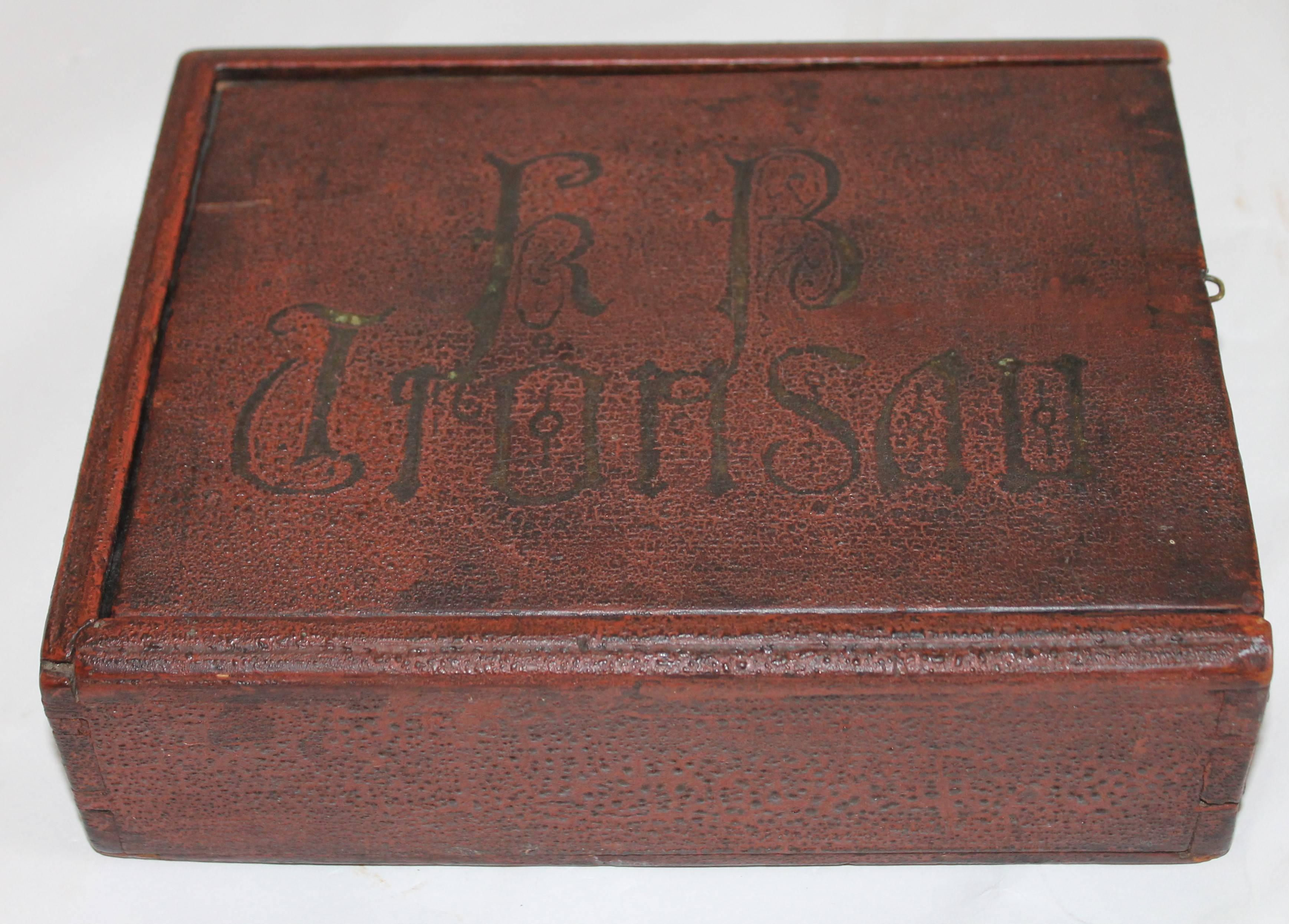 This fine handmade and dovetailed 1780-1800s red painted candle box is in fine as found condition. It is from Lancaster County, Pennsylvania in original undisturbed red crazed surface. There is gilded letters on the top that are somewhat worn and