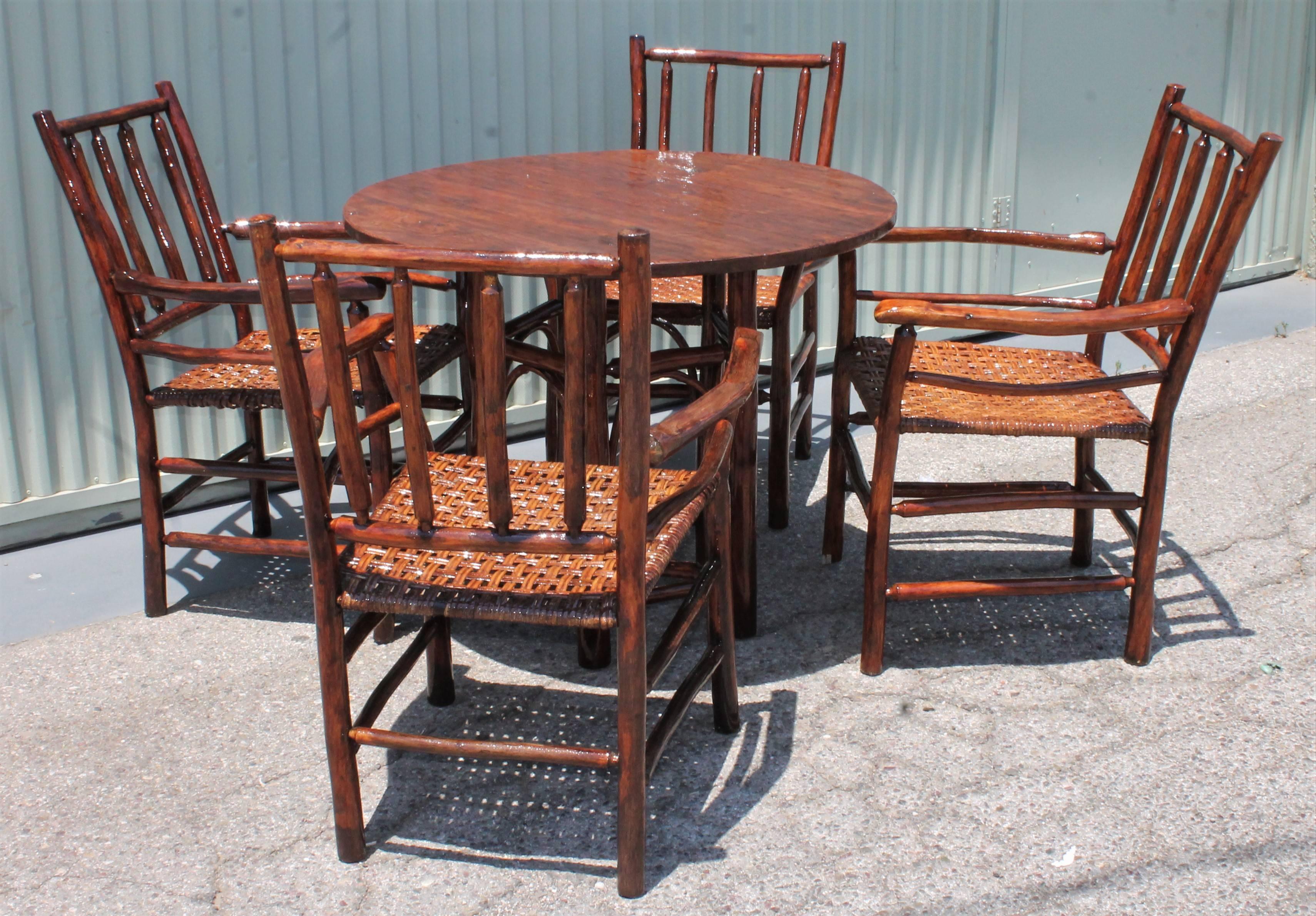 This amazing indoor / outdoor signed Old Hickory Table & chairs is in amazing and sturdy condition with a nice mellow patina. The entire set has a coat of boat varnish, outdoor protector on it. This is so it is protected from the rain or outdoor