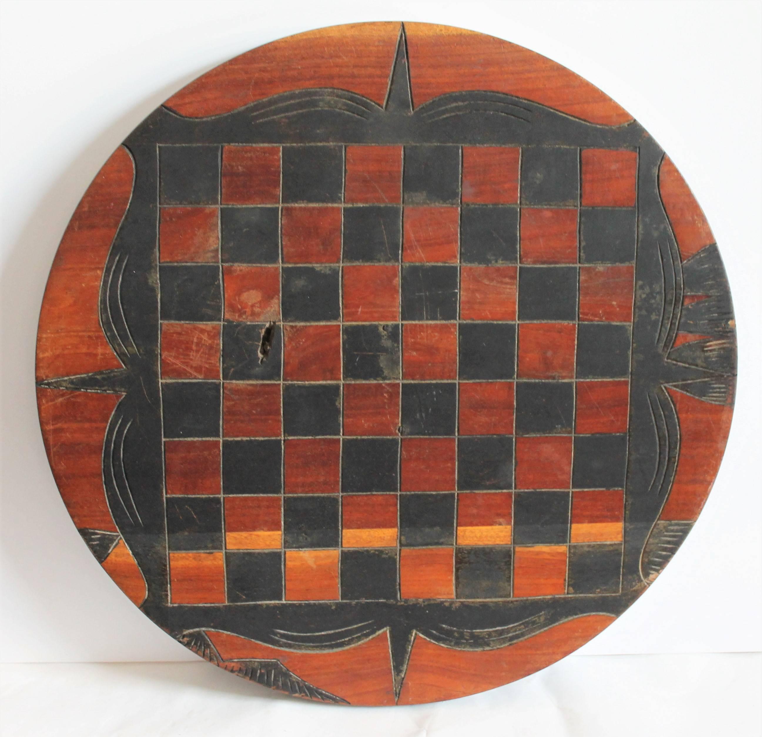 This unusual game board is a round reversible and is in black paint with a cow on the reverse. It came out of a unusual Folk Art collection. I've never seen a game board like this one. They said it came out of the mid-West.