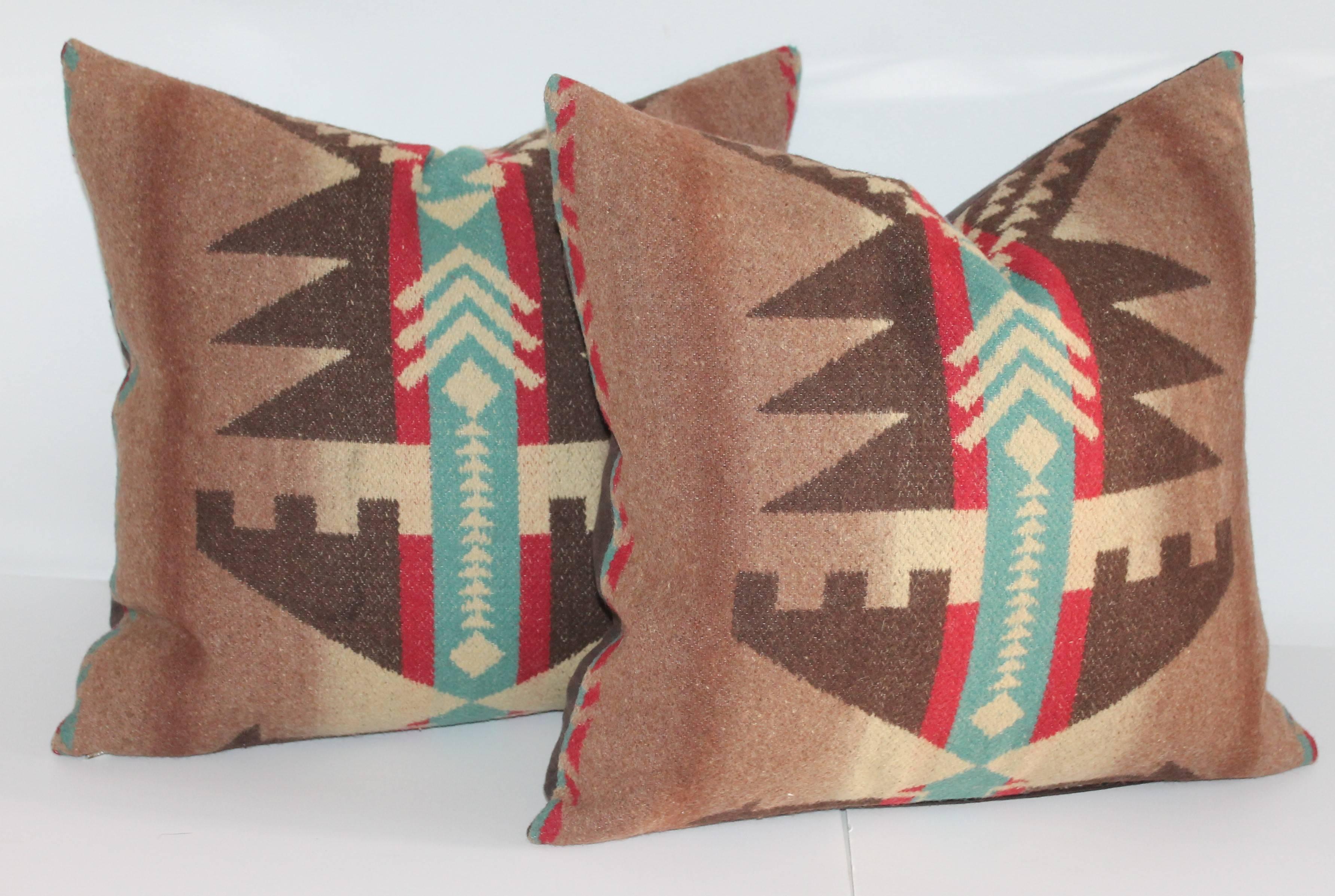 These Beacon blanket pillows with a Native American motif are in great condition and have a chocolate brown cotton linen backings. The large bolster pillow is measure: 16" x 28" and the two square pillows are 16" x 16 ". Sold as