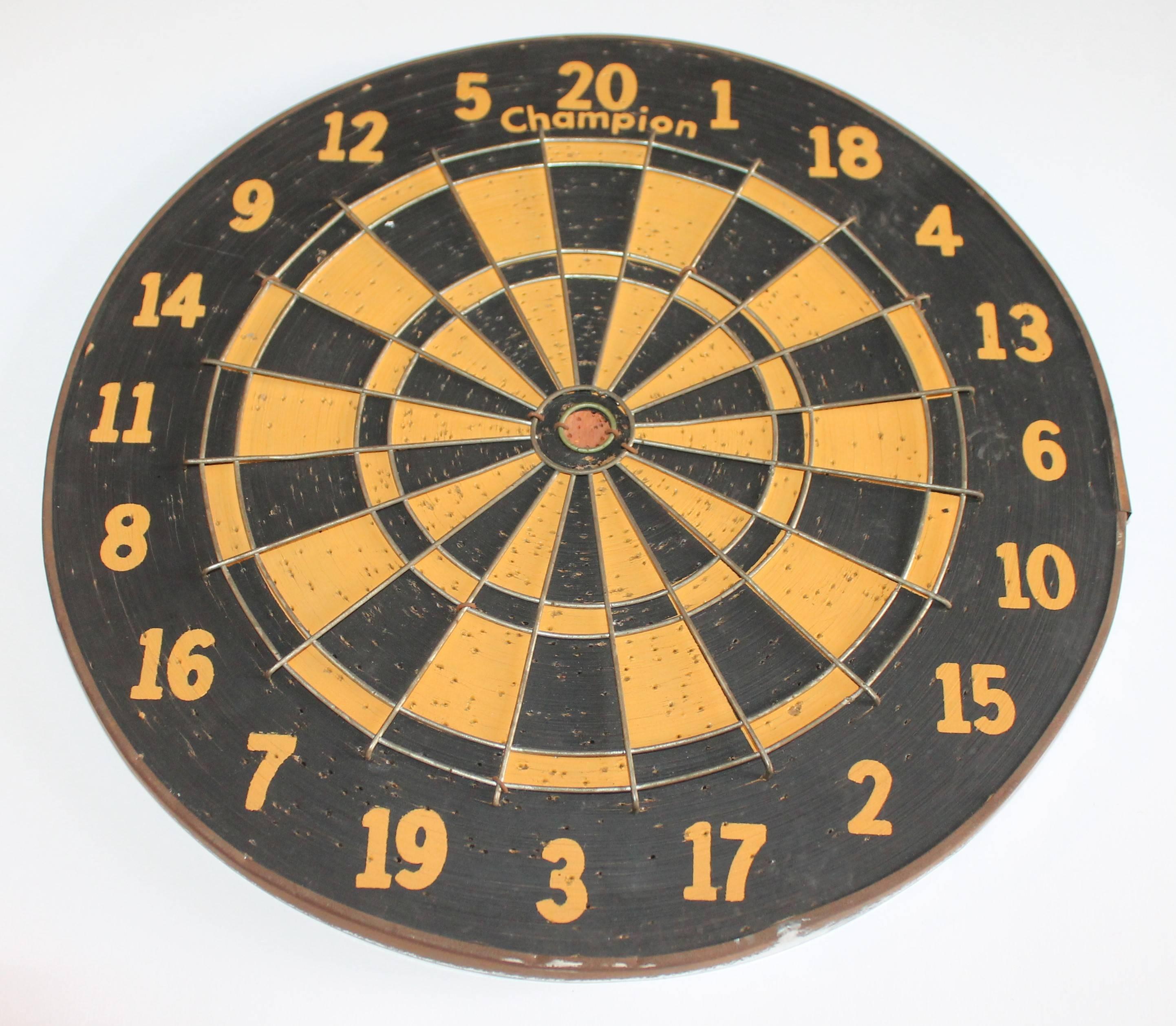 This funky dart target board is double sided and has baseball game on one side and regular target with points on the other side. The trim is the original tin binding or border. The condition is very good. Usually found in bars or pubs. It is all