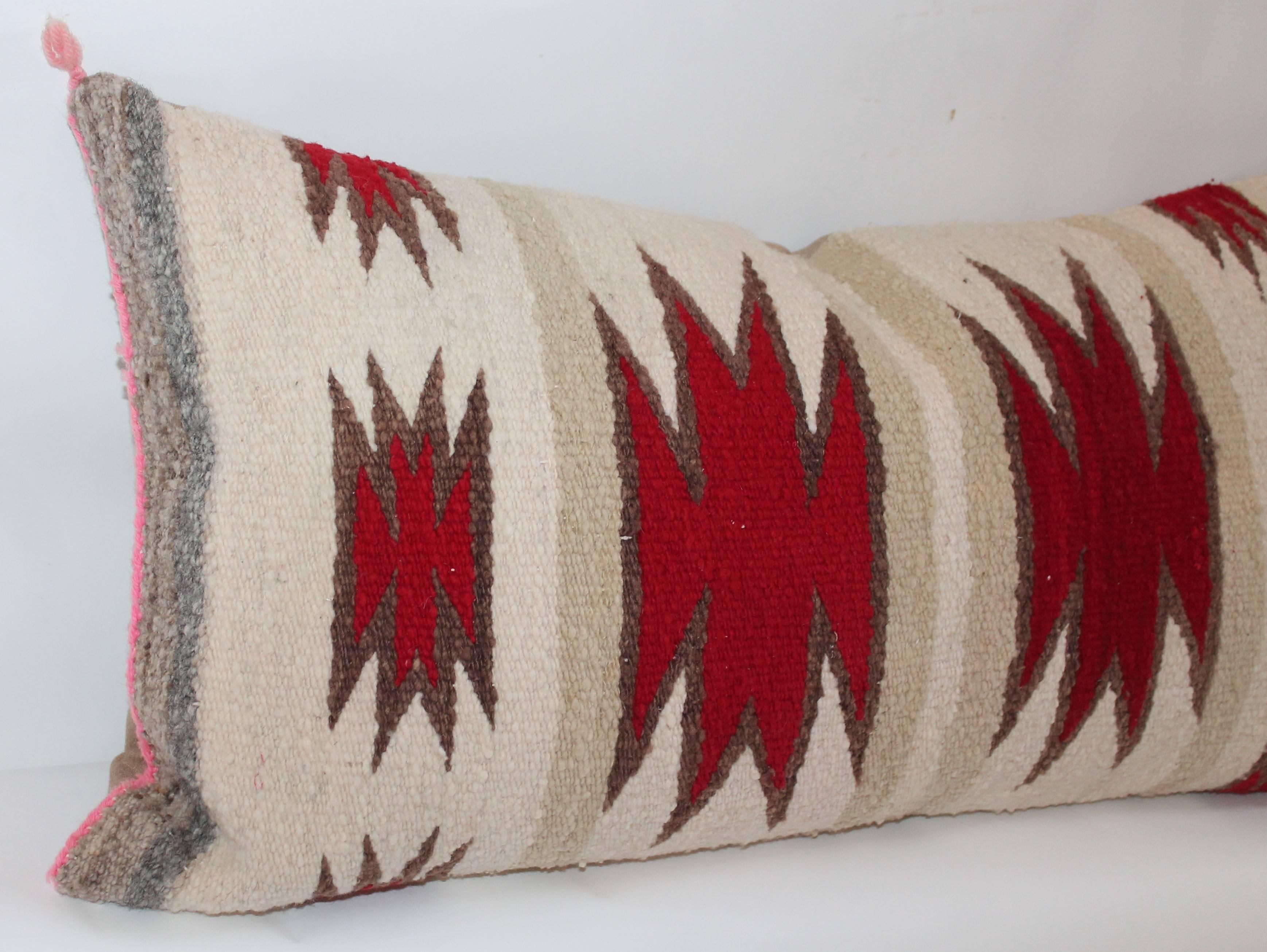 This early and graphic Navajo saddle blanket weaving pillow is in good condition and has a slight fade throughout. The backing is in a tan cotton linen. The insert is down and feather fill.
