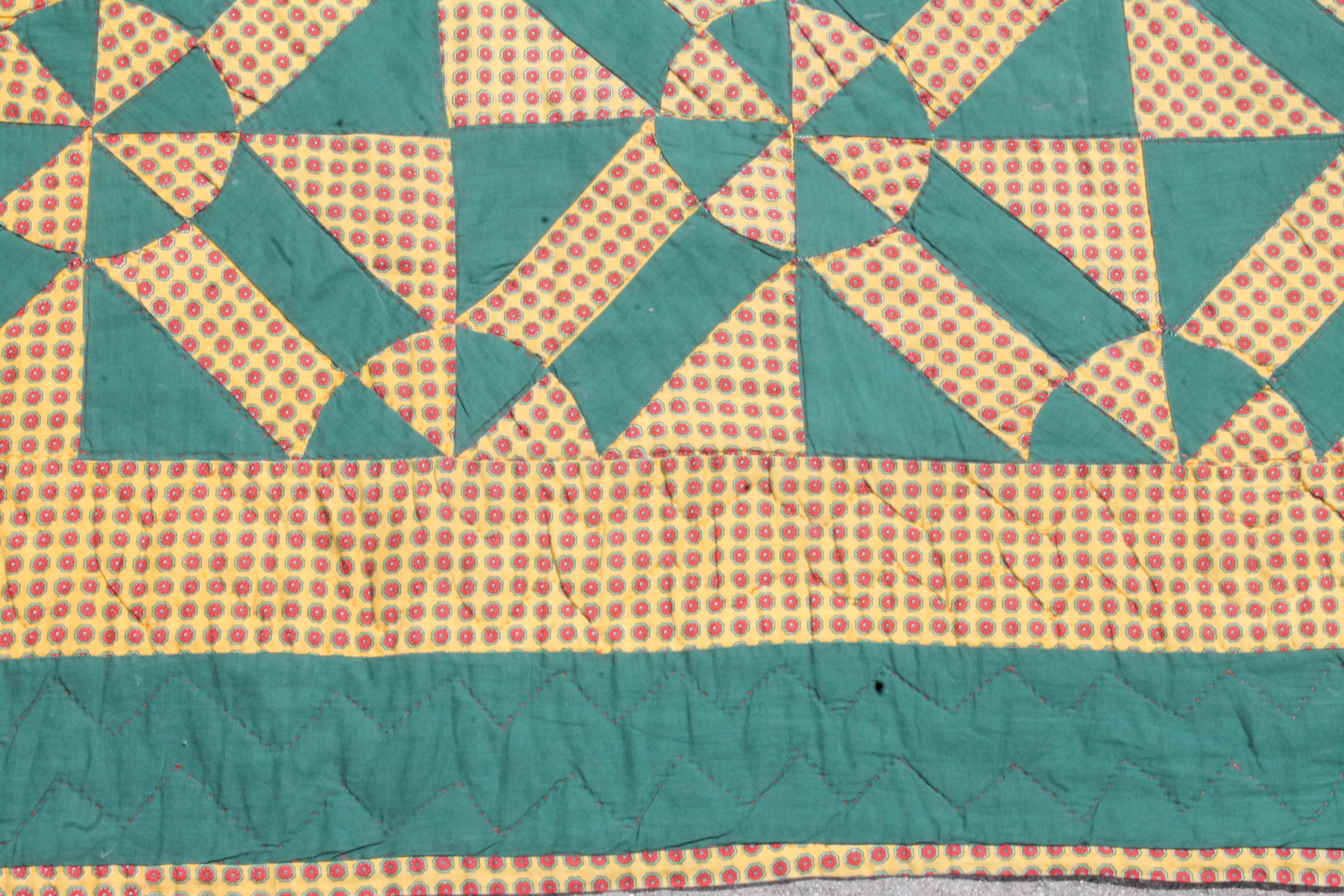 This interesting 19th century, geometric pinwheels in solid green and tan calico cotton fabrics. The backing is a continuation of calico fabric.