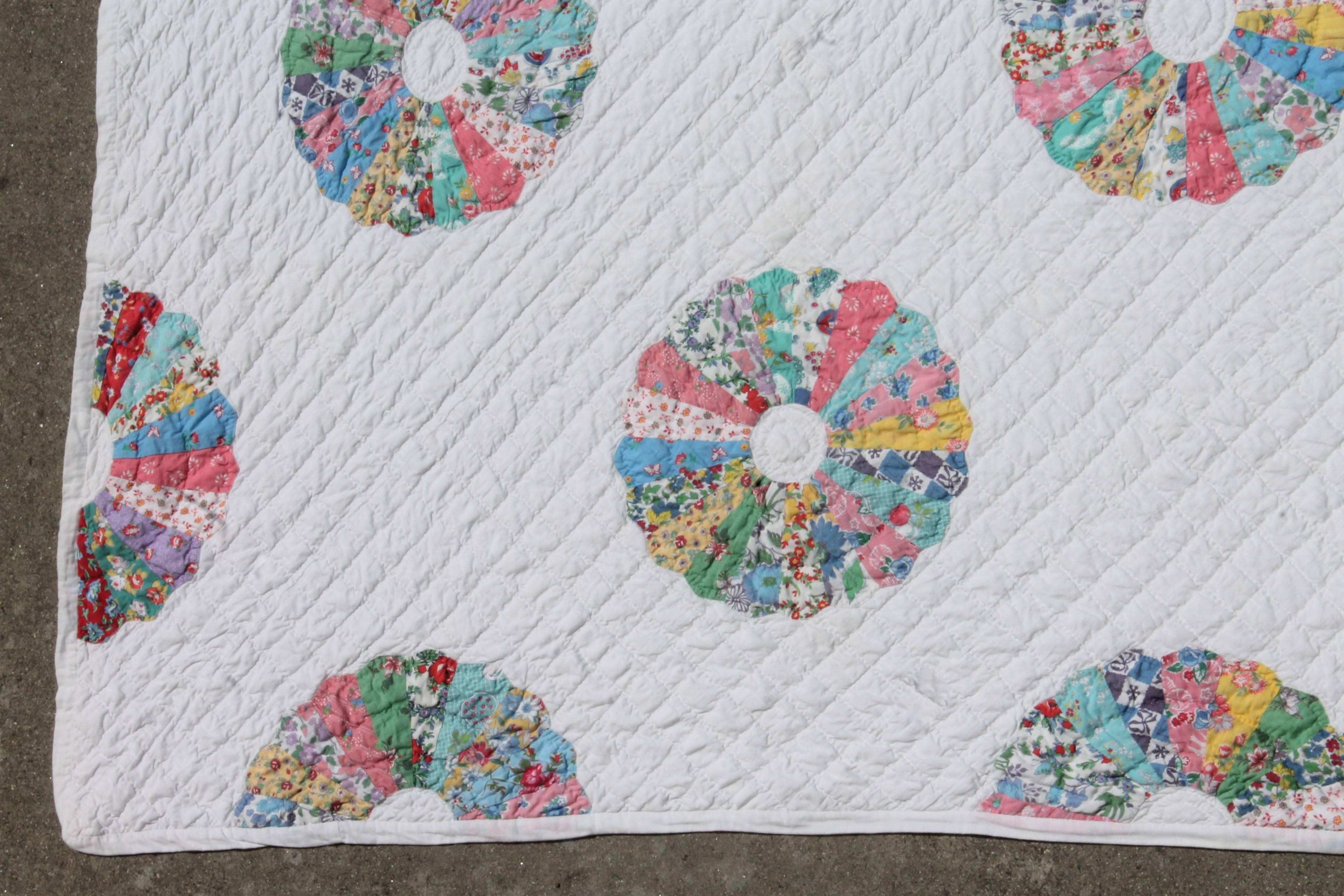 This fancy 1930s Dresden plate pastel appliqué quilt is in fine condition. The quilting and appliqué work is superb! There are tiny small area of age spots in one area hardly visible.