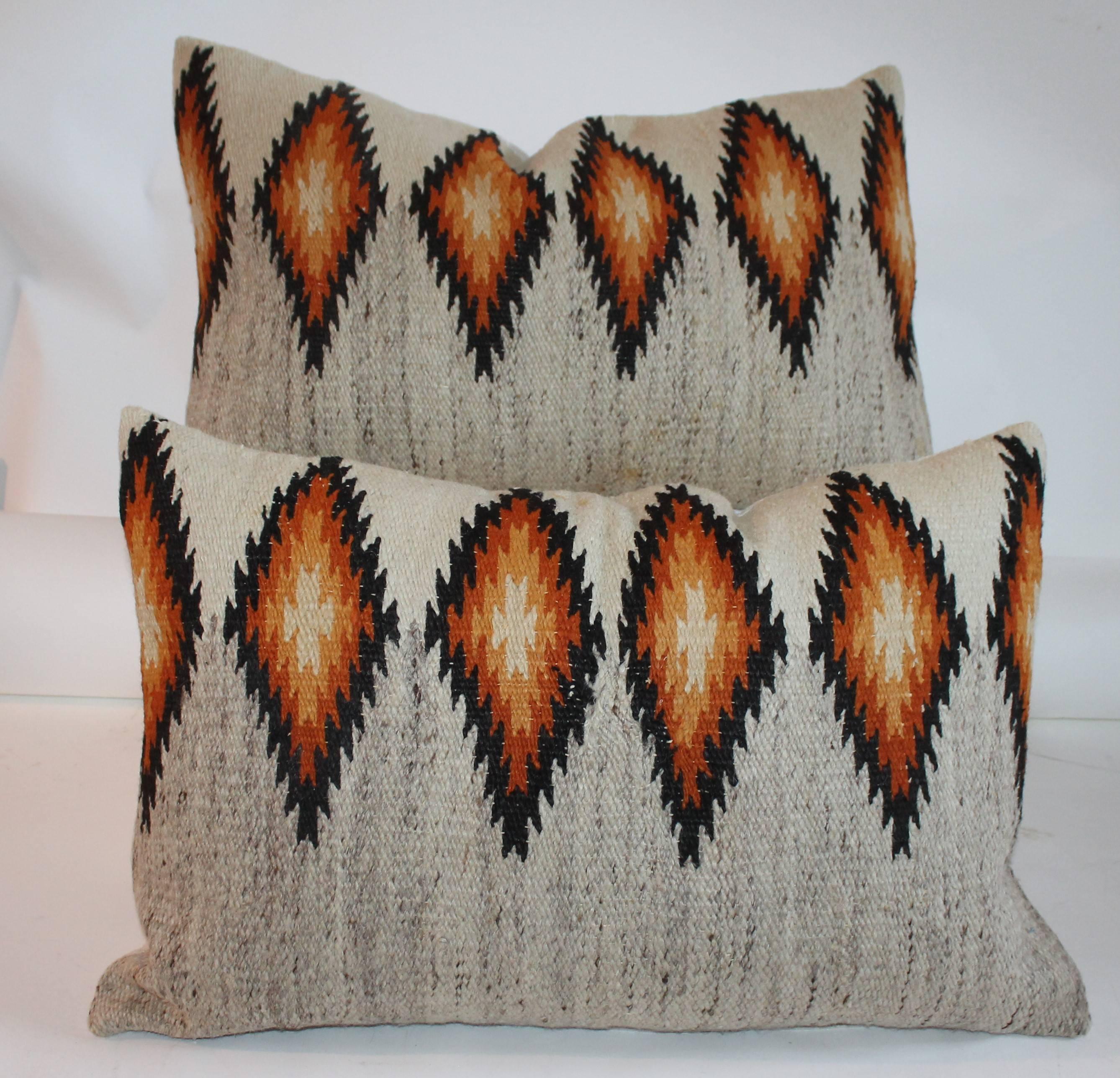 These fine geometric eye dazzler pillows are in a golden rod color and trimmed in black. The back ground is in a natural color. The backing is in natural cotton linen. Down and feather fill.