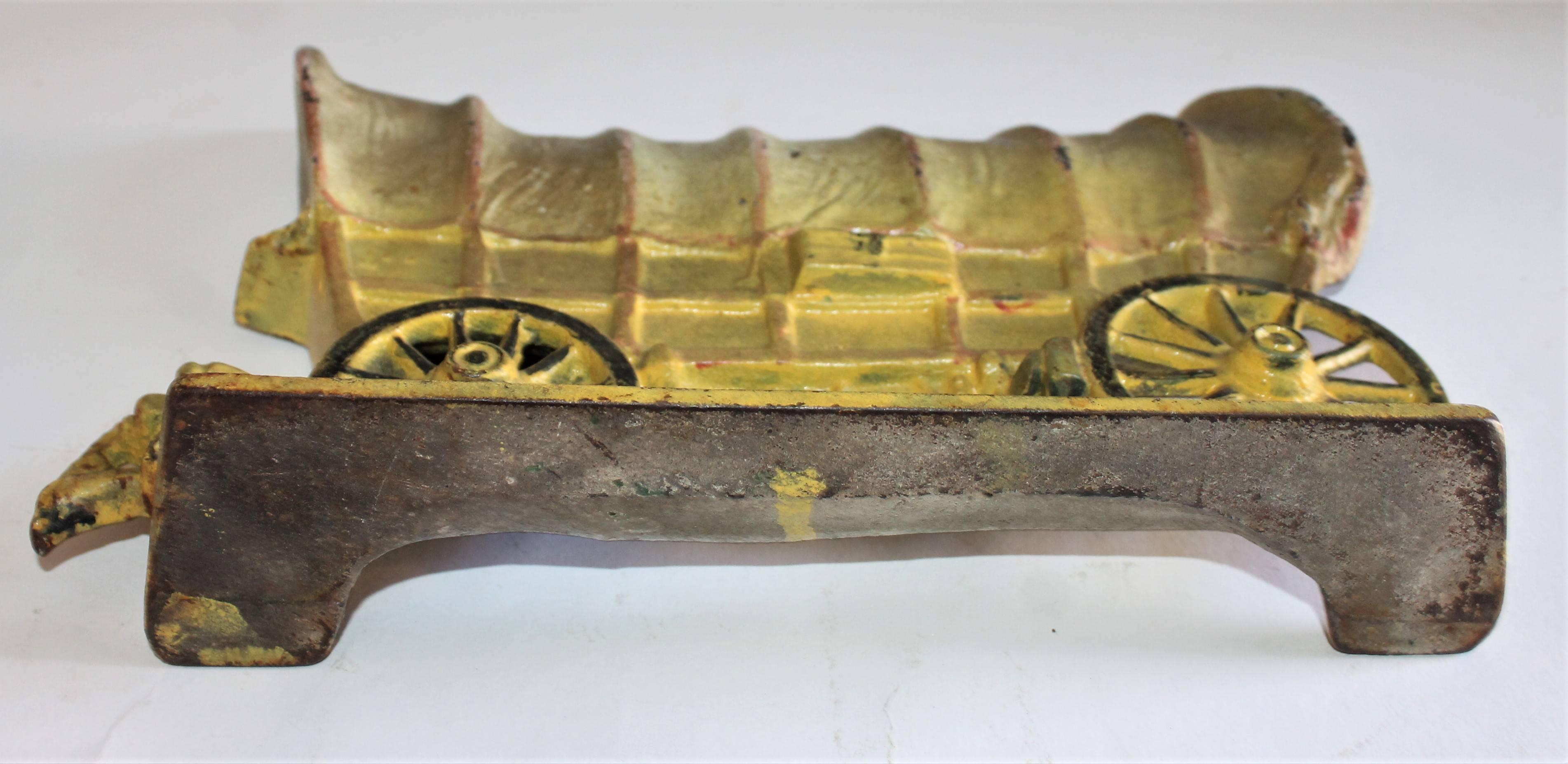 Early original painted stage coach cast iron doorstop. This fine iron Hubley doorstop and is in really great condition. It is in vibrant original surface. Wonderful patina.