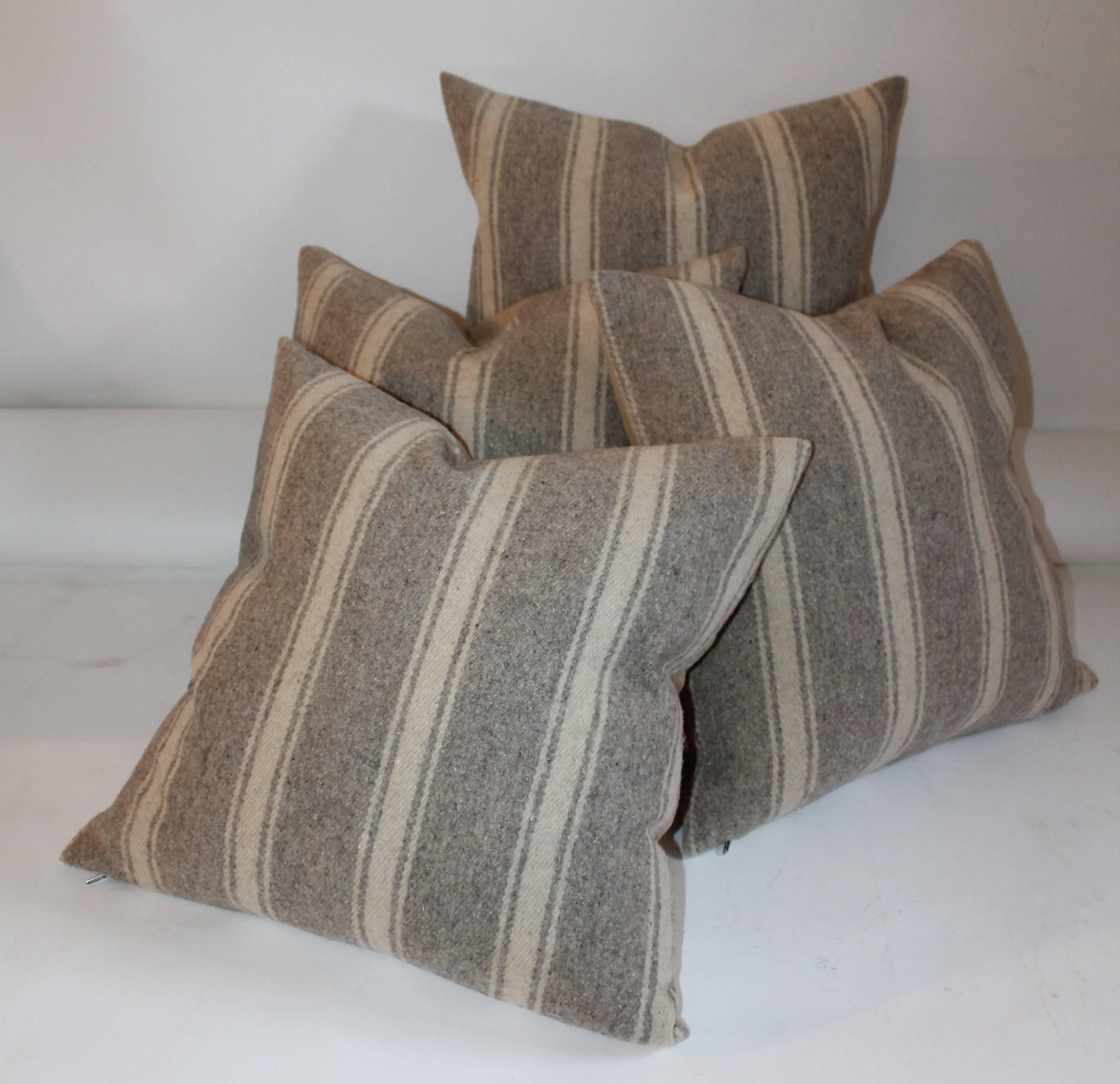 These handwoven striped saddle blanket weaving pillows are in fine condition. They have a soft cotton linen backing. Sold as a group of four.