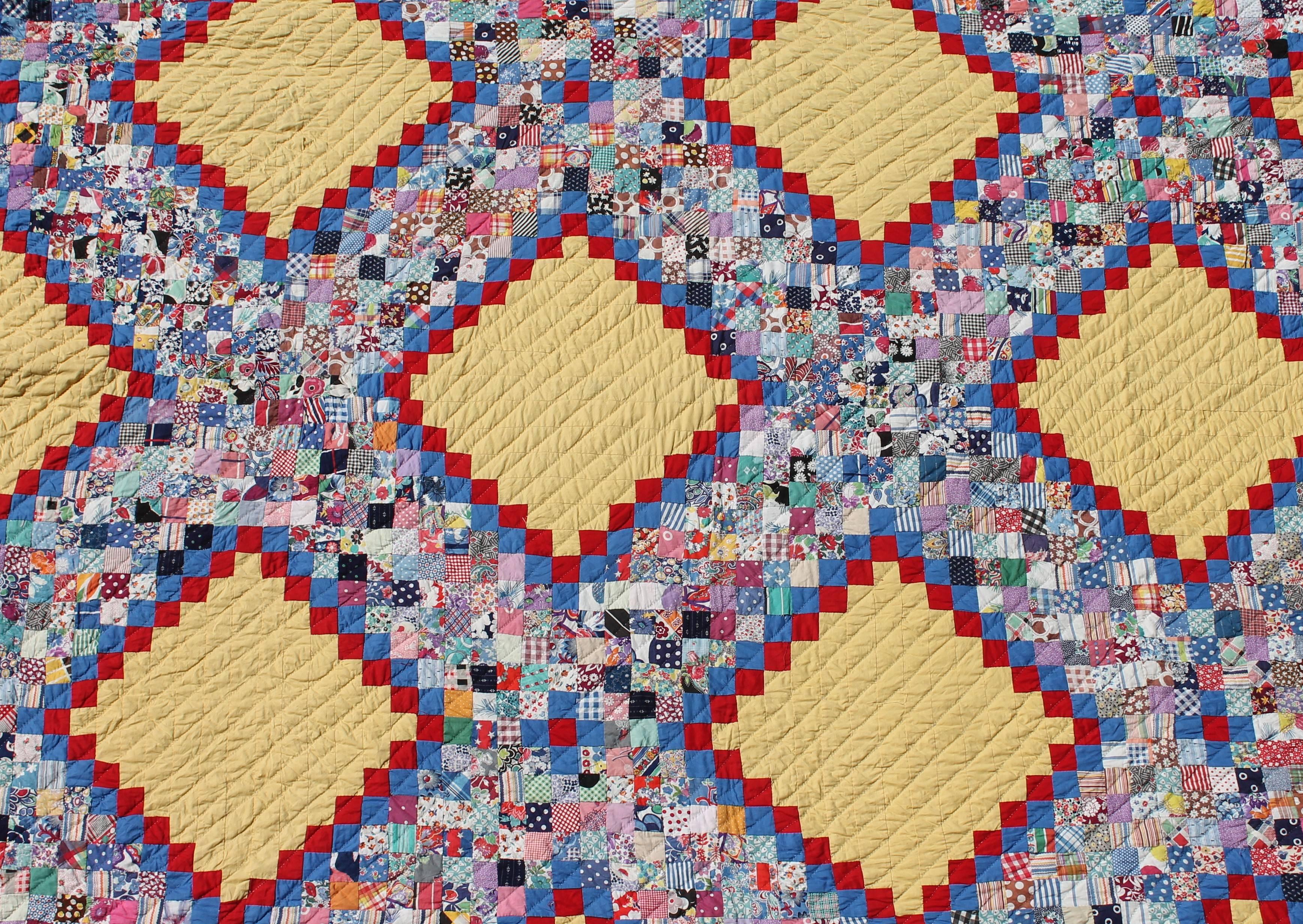 This fine postage stamp chain quilt is in great condition and fine piecework. The back round is a mellow yellow with a sky blue border.