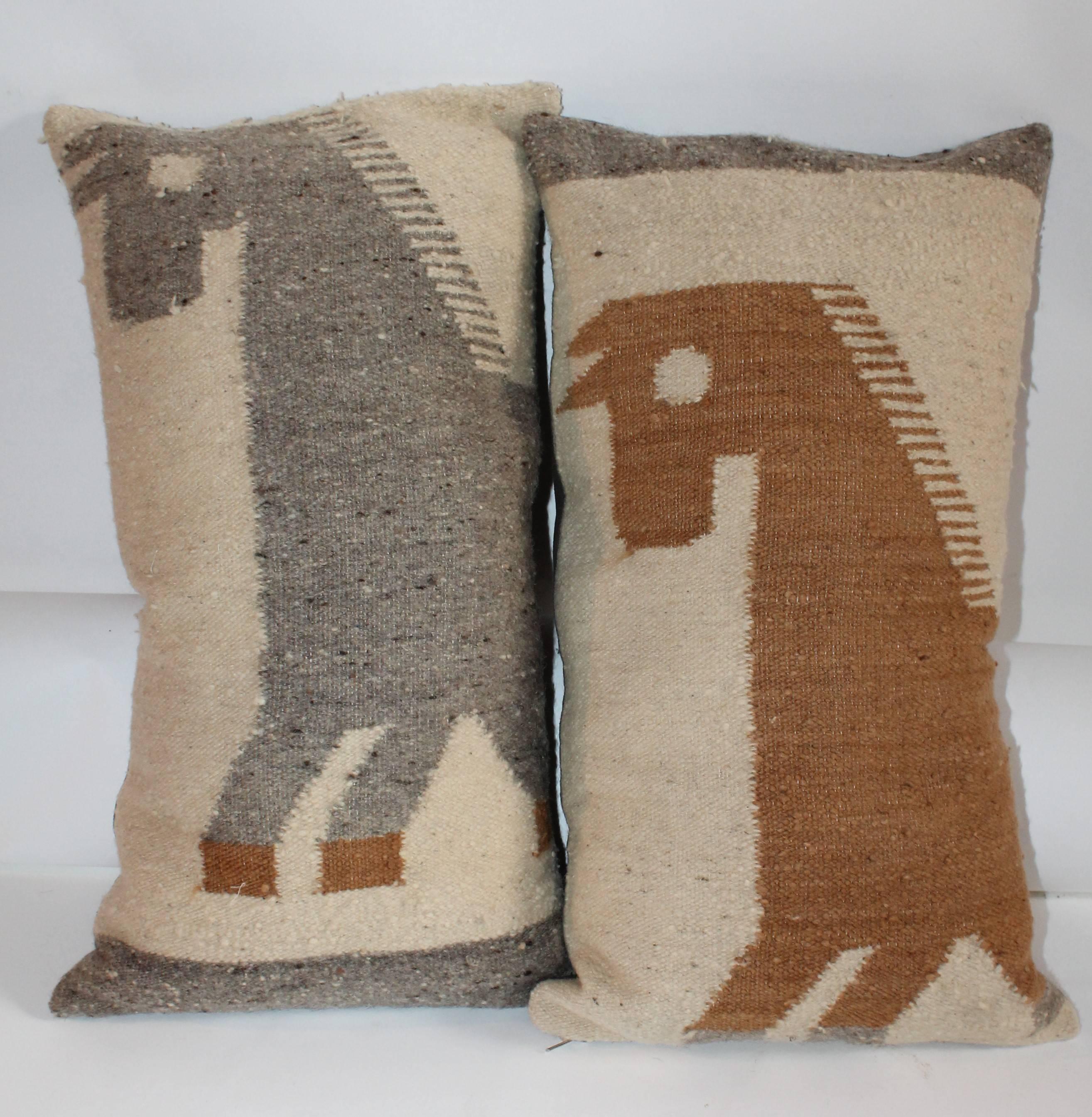 These handwoven horse weaving's pillows are in great condition and have taupe linen backings. The inserts are down and feather fill. Sold as a pair.