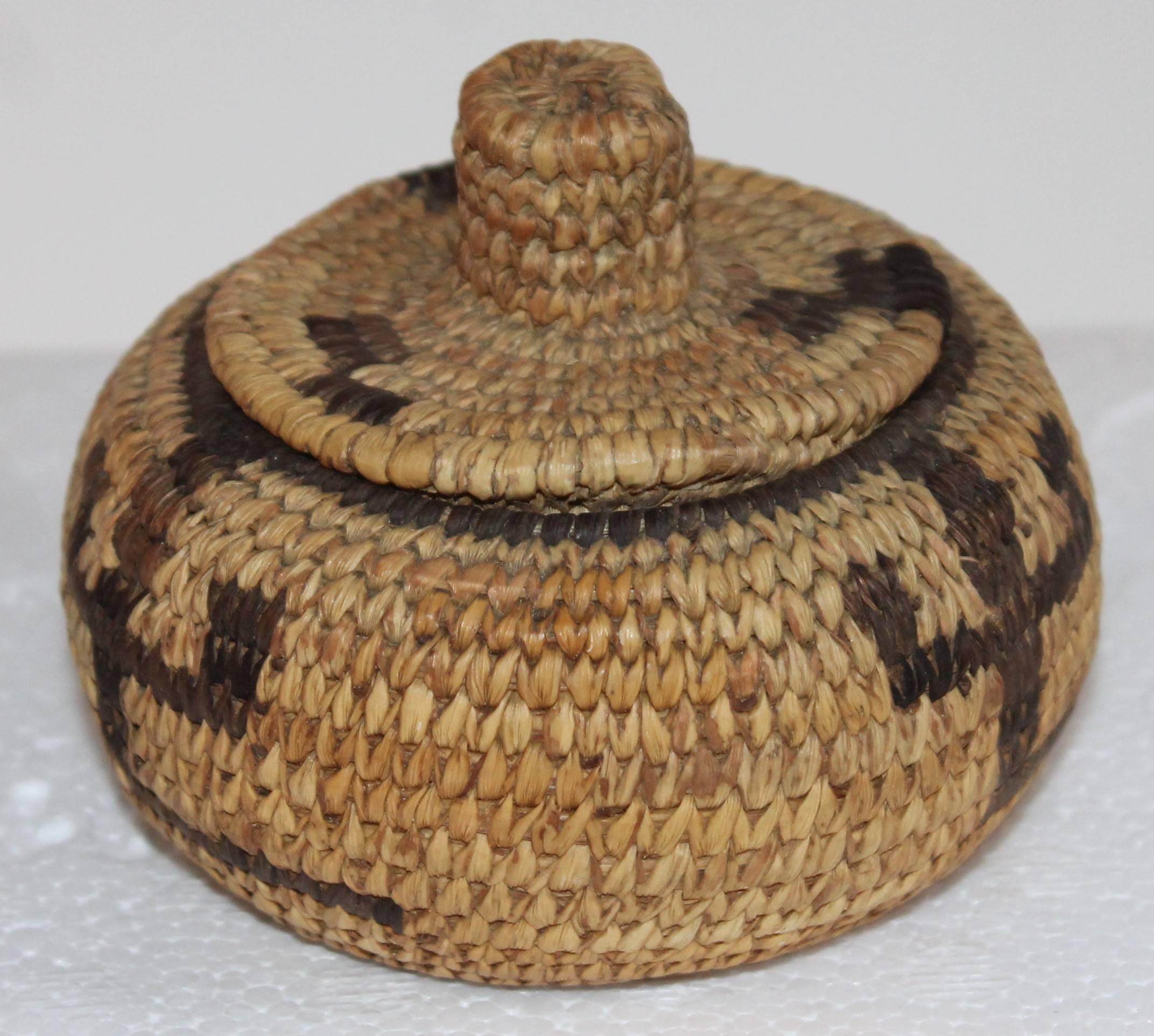 This fine little gem early 20th century Pima Indian basket is in pristine condition. The lid sits snug on the top of this little basket.